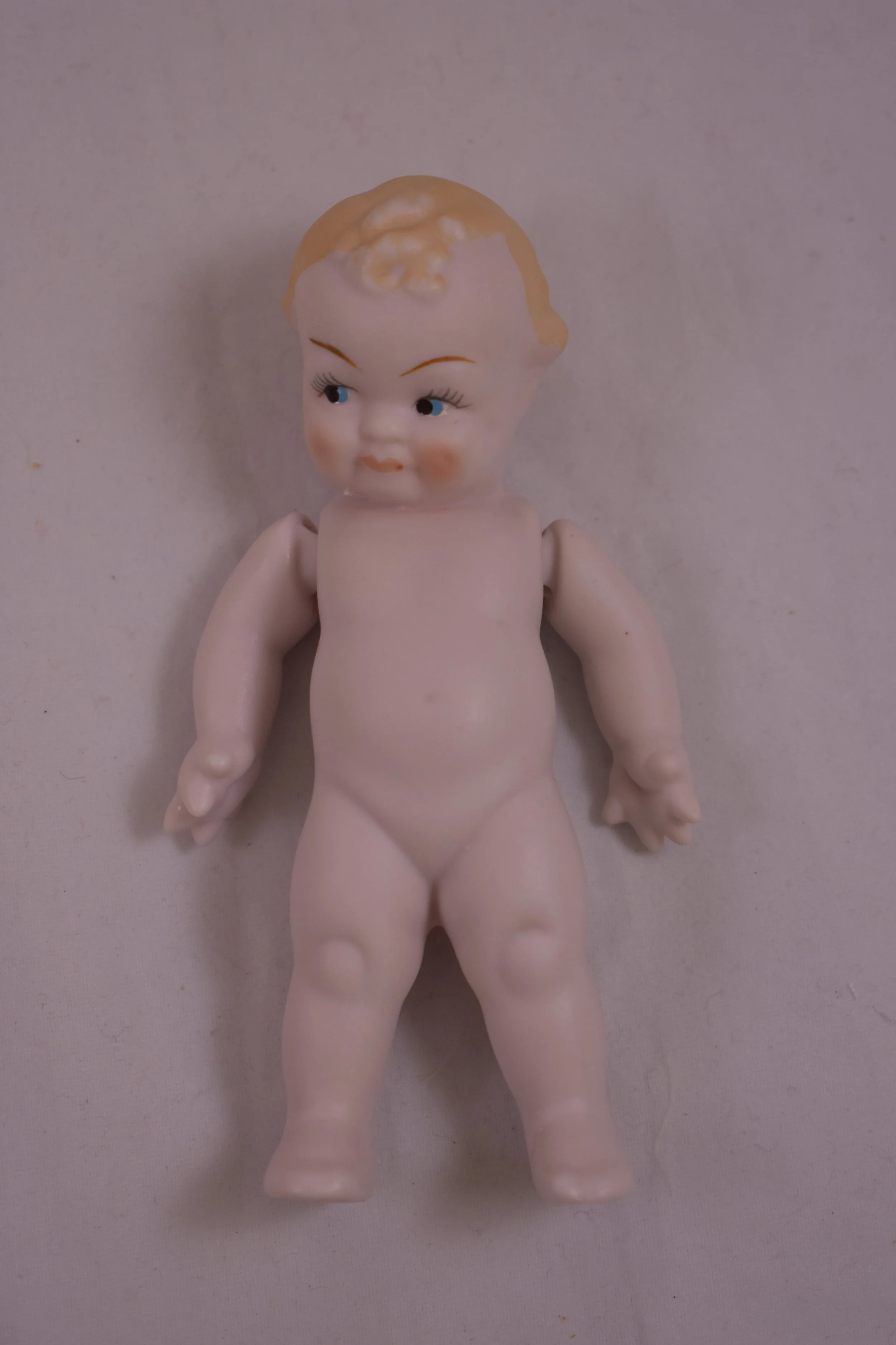 This mischievous little boy is made entirely of bisque