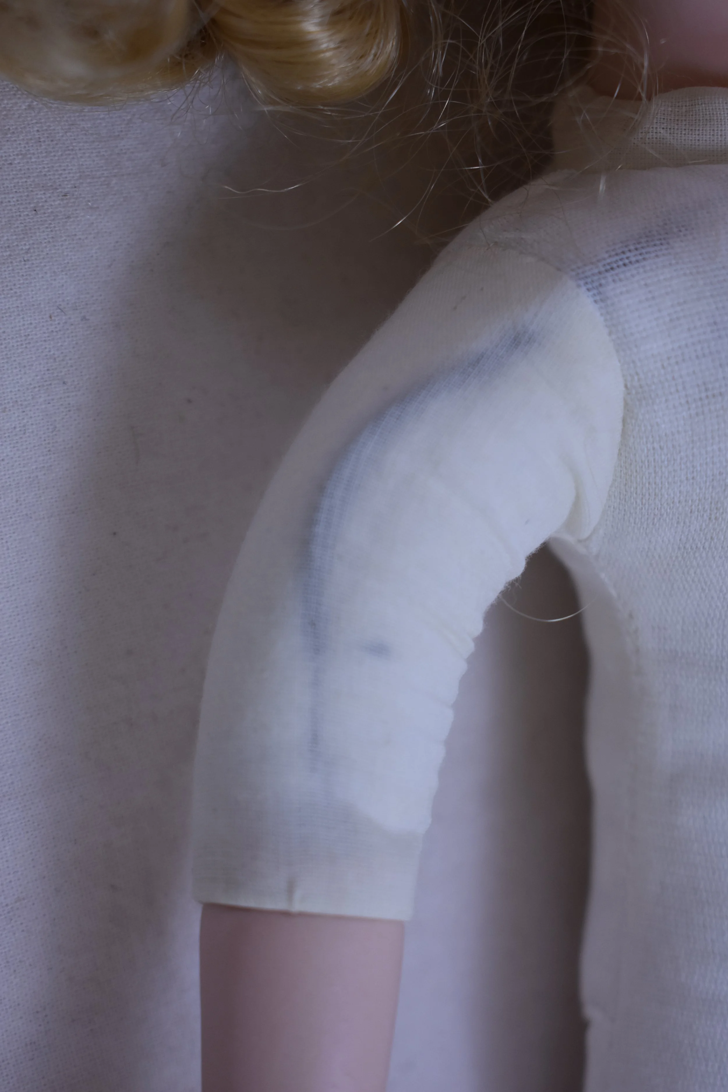 Cloth body attached to arms and legs.  The arms have an inserted wire to allow for posing. 