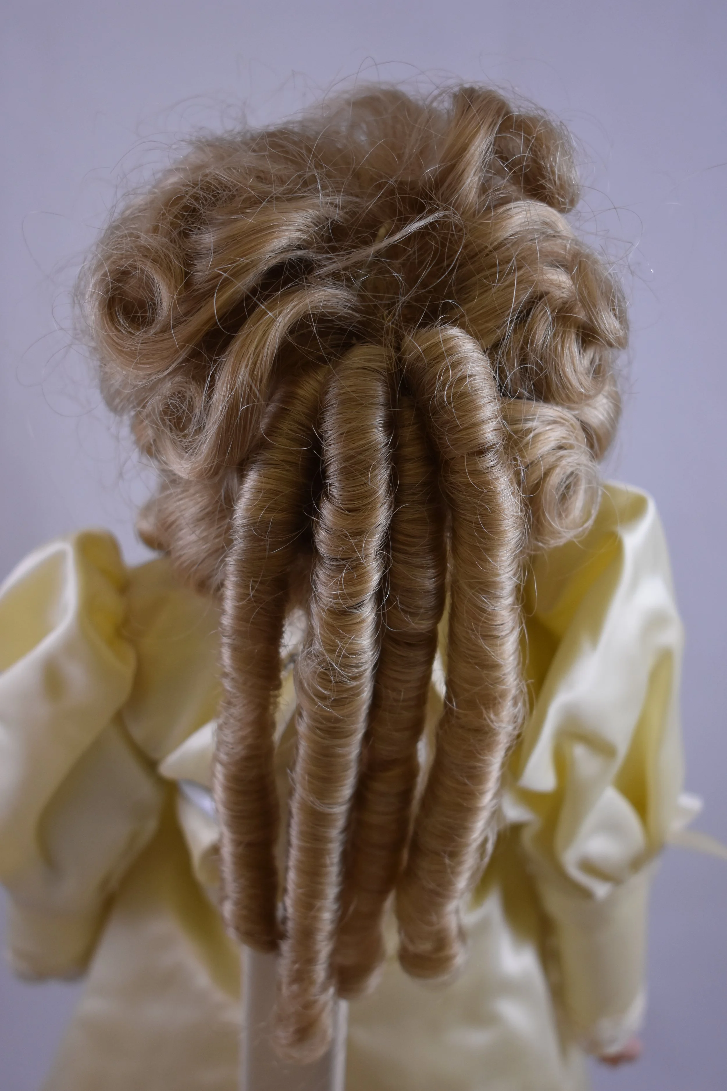 Elaborate coiffure, back view.