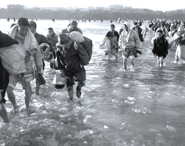 South Korean refugees cross a frozen river to escape the fighting.