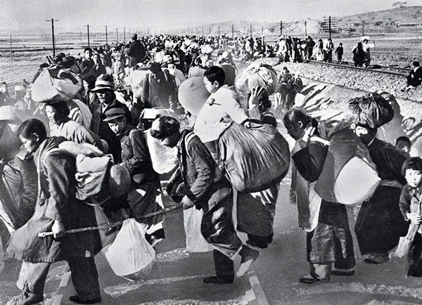 Refugees crossing a railway