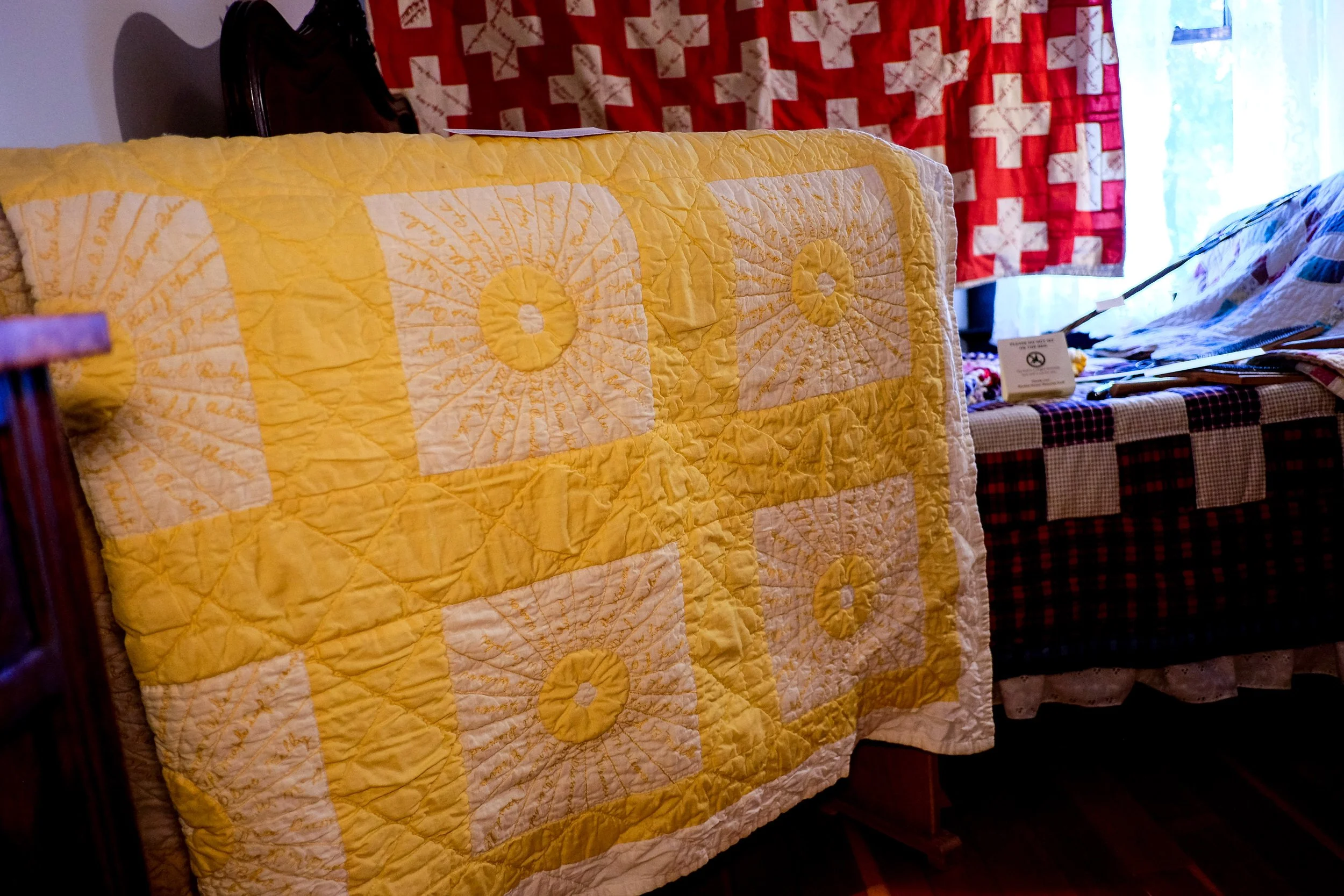 This quilt is called a signature quilt which became popular in the 19th century. They were made as gifts for people moving out west, as a way of honouring or documenting a community, and as a fundraising tool for missionary work or for supporting the