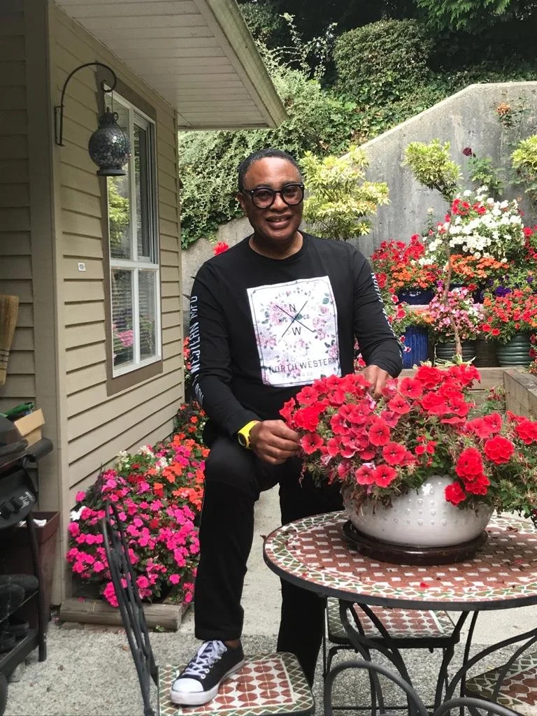 Mel, an avid gardener, at his Coquitlam home with some of his prized flowers.