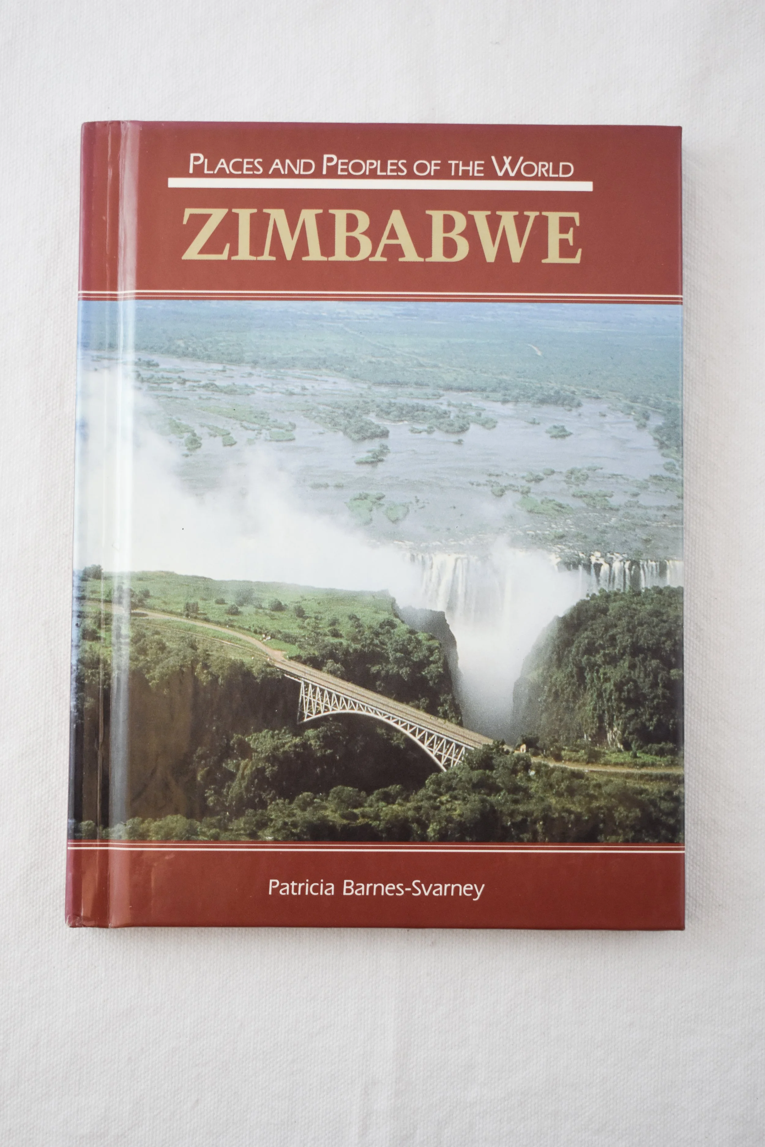A promotional book for tourists used to promote Zimbabwe’s natural beauty. Victoria Falls is featured prominently on the cover. Also seen is Victoria Falls Bridge over the Zambezi River, which forms the border between Zimbabwe and Zambia.