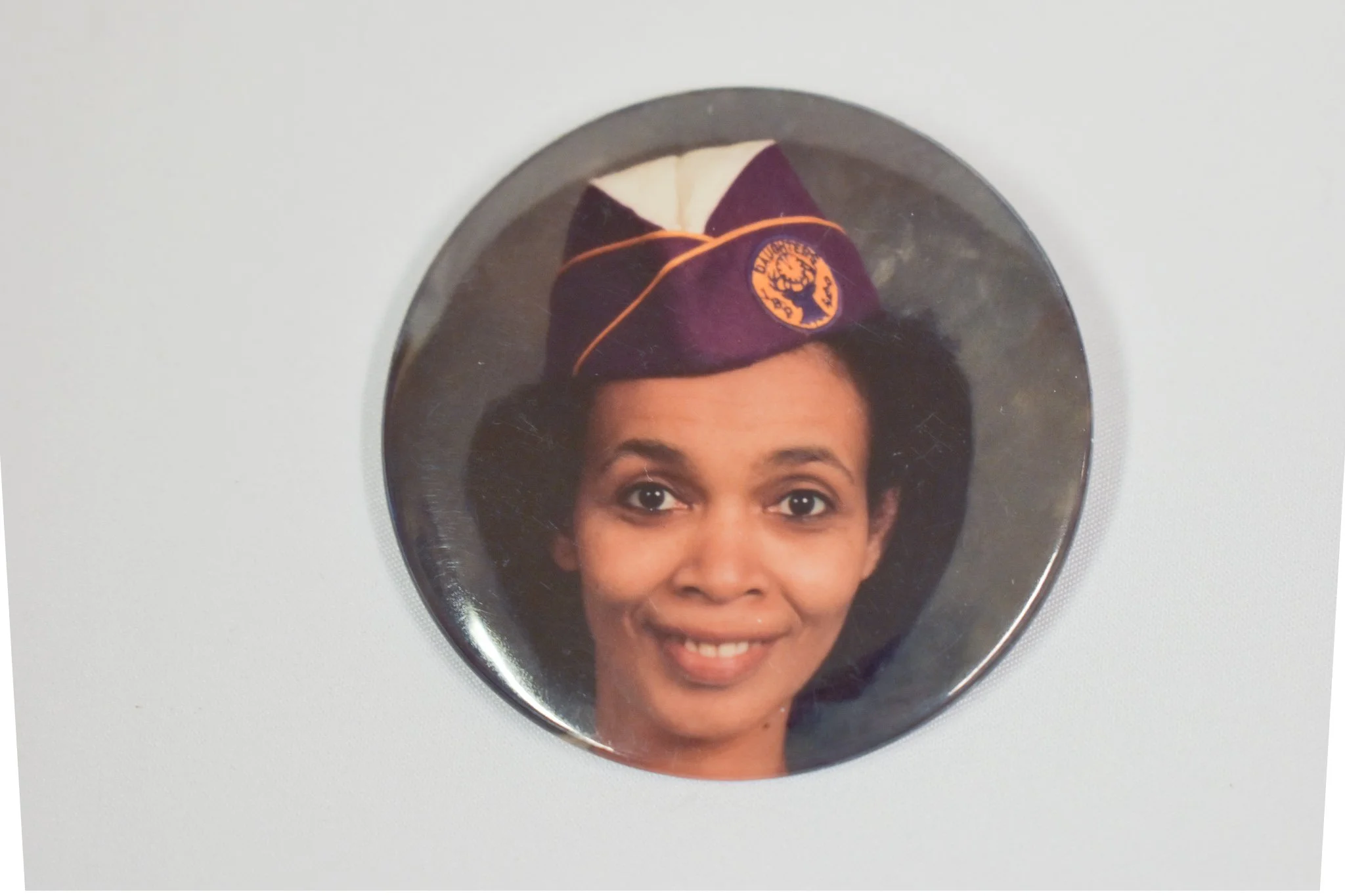 Headshot on a pin of Candace’s oldest sister, Leslie. Growing up in a big family, Leslie often help raise Candace and her younger siblings. Candace has always looked up to her big sister, Leslie. Leslie’s hat has a patch from the Elks, a community or