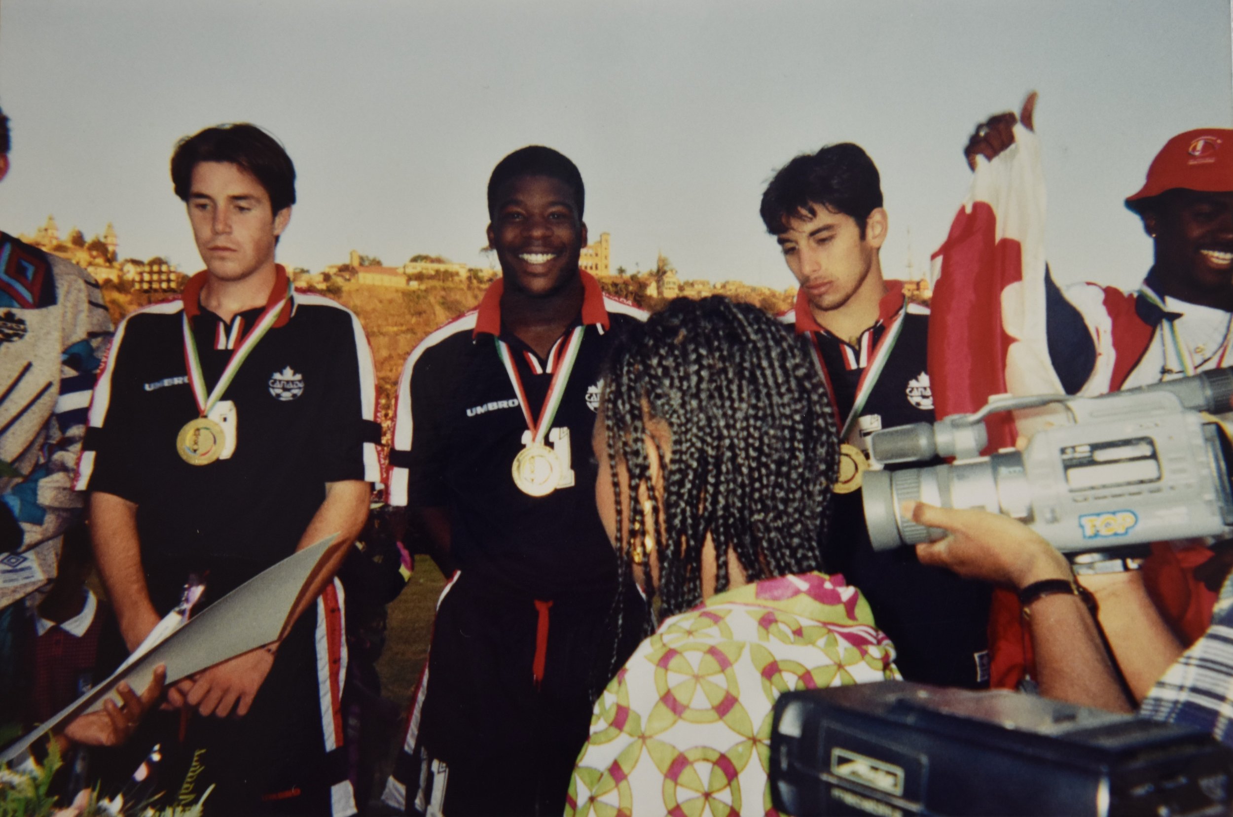 Chris Clarke (centre) receiving a gold medal as a member of Canada’s Francophone Games soccer team at the 1997 Francophone Games in Madagascar.