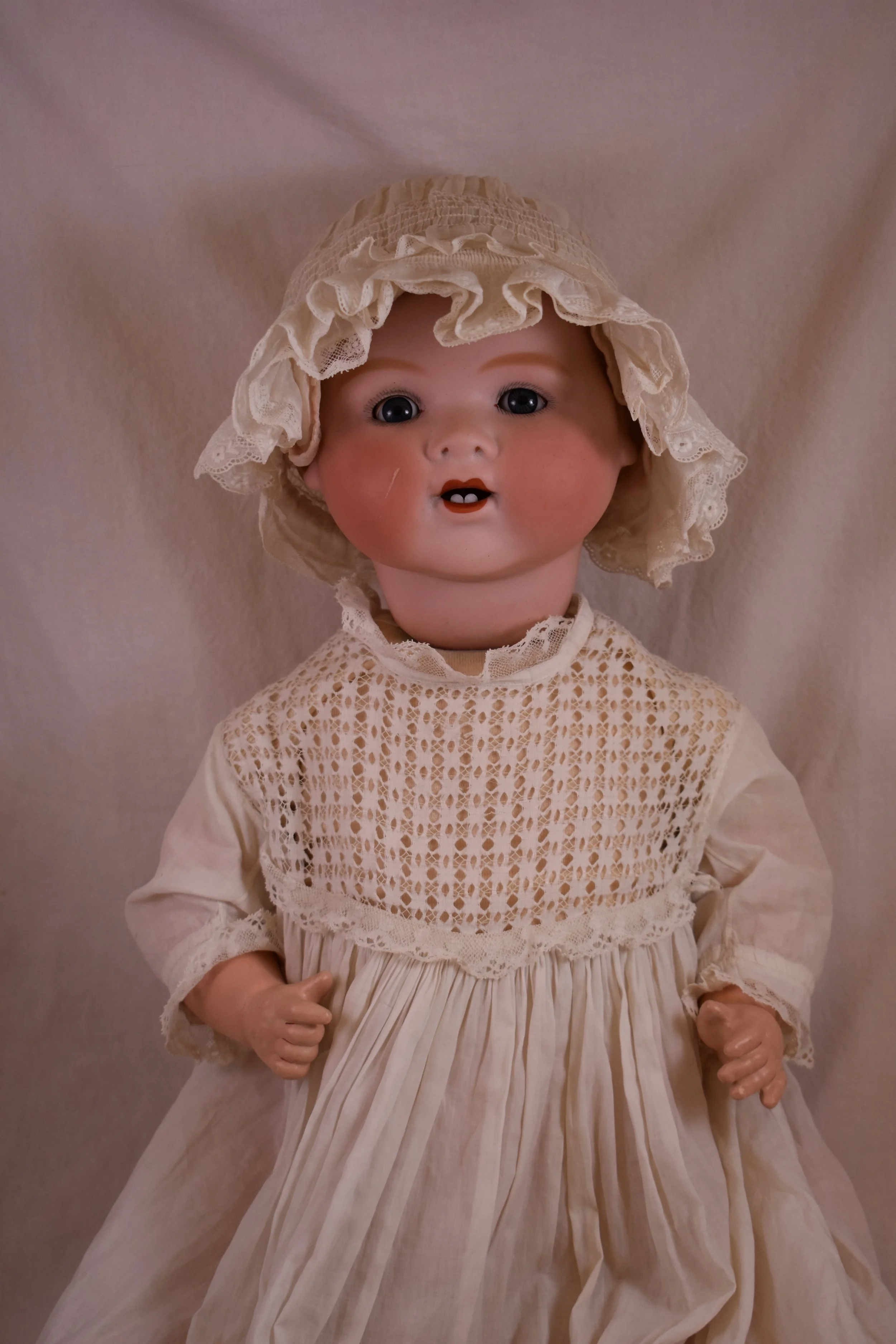 My Dream Baby Doll, mold 351, featured an open mouth, two front teeth, painted hair, and had either painted eyes, or sleep eyes.  This Dream Baby has sleep eyes. 