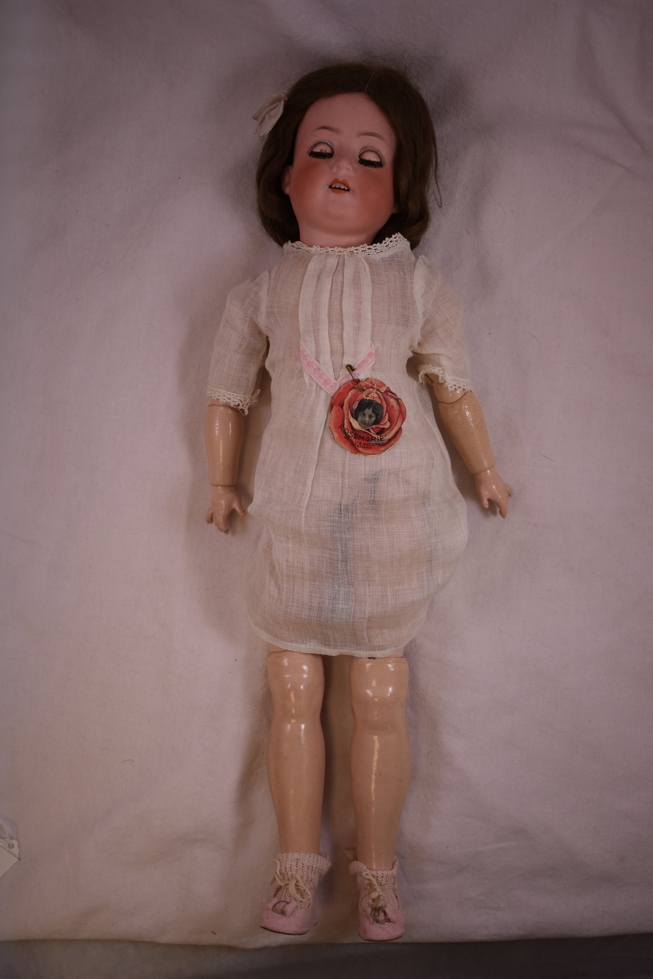 This Heubach doll has a bisque head, with an articulated, composite body.  