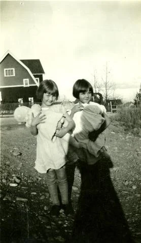 Inez Birtch and a friend, holding their dolls, Coquitlam, circa 1930s.
City of Coquitlam Archives, CA CCOQ C4-S1-SS3-F01-MH.2006.49.1g