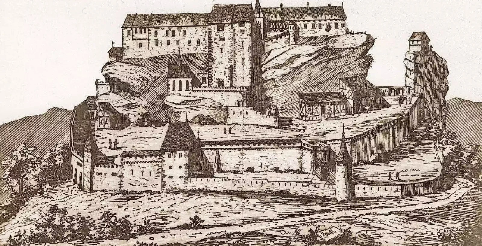 A detailed historical illustration of a medieval castle built on a rocky hill, featuring stone walls, towers, and various structures interconnected with walkways and staircases, surrounded by a landscape with trees and open fields.