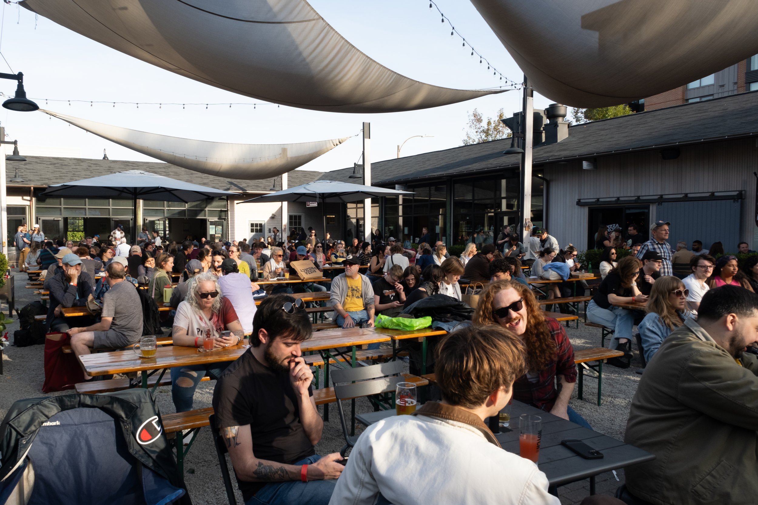BRIGHTON,MA- People were sitting together and chatting with fun. The photo shot in the Left of The Charles Fall Music Festival at Oct 19. 
