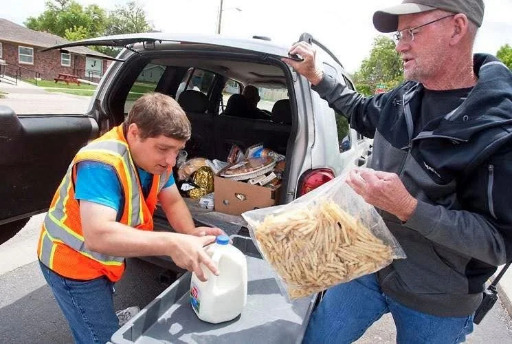 Michael as a young man unloading supplies from a truck.