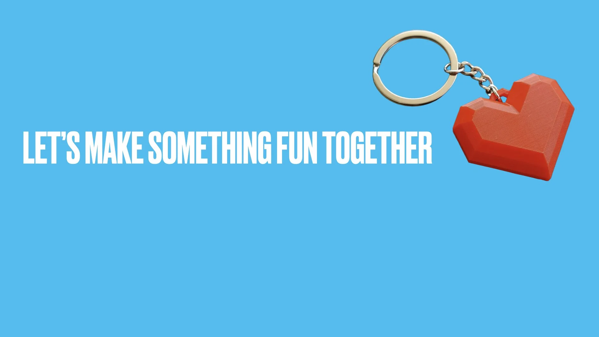 Light blue background with bold white text that says, "Let's make something fun together," and a red heart-shaped object attached to a silver keyring.