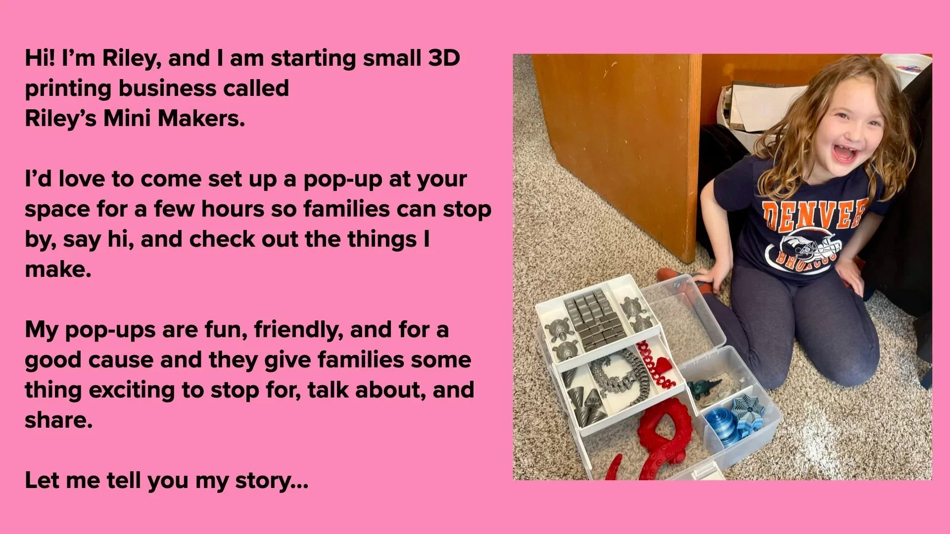A young girl with curly hair, wearing a Denver Broncos T-shirt, is squatting on the carpeted floor next to a plastic container filled with various small 3D printing parts. She is smiling and looking up.