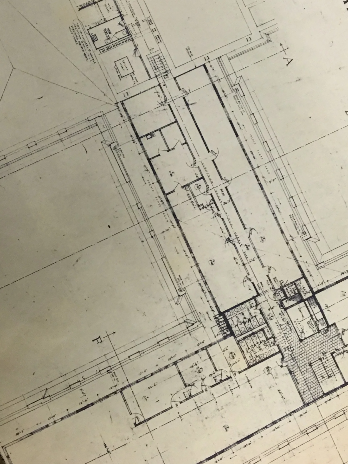 Architectural blueprint of a building floor plan with various rooms and measurements.