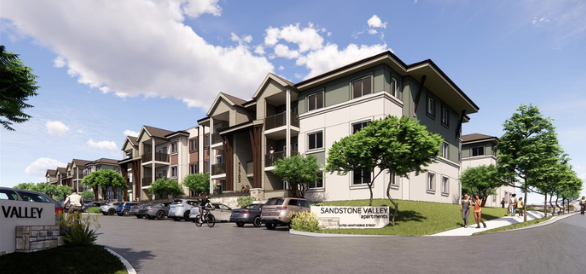 A modern apartment complex with multiple stories, surrounded by small trees and a parking lot filled with cars and bicycles, under a partly cloudy sky.