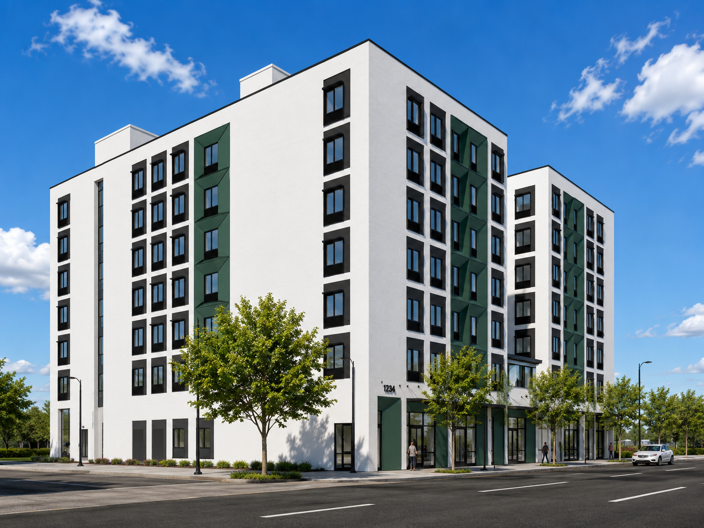 A modern multi-story apartment building with white exterior walls, black window frames, and green accents, alongside a street with trees and pedestrians.