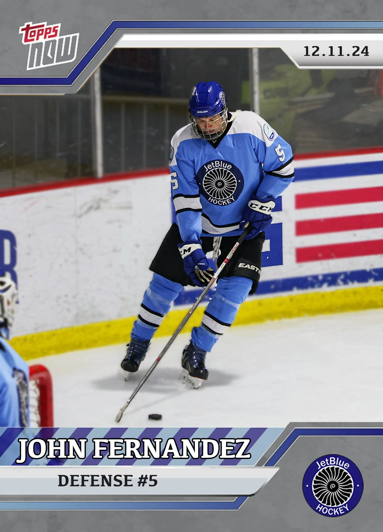 Hockey player wearing a blue and white JetBlue Hockey jersey, black hockey shorts, and a blue helmet, on ice with a hockey stick in hand, near the goal. The image includes text with the name John Fernandez, his position defense, #5, and the date 12.1