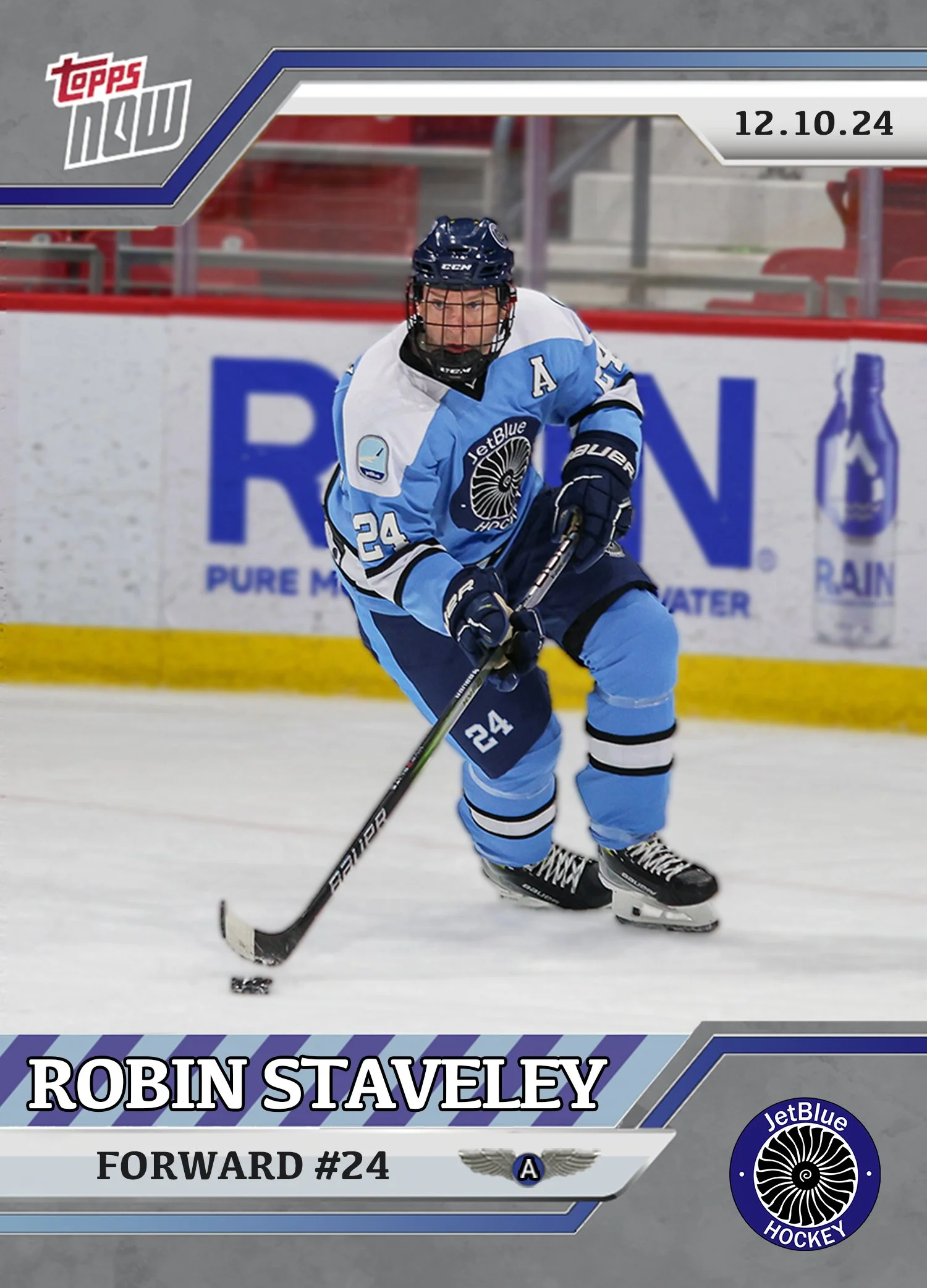 Hockey player wearing a blue and white uniform with the number 24, skating on ice while holding a hockey stick.