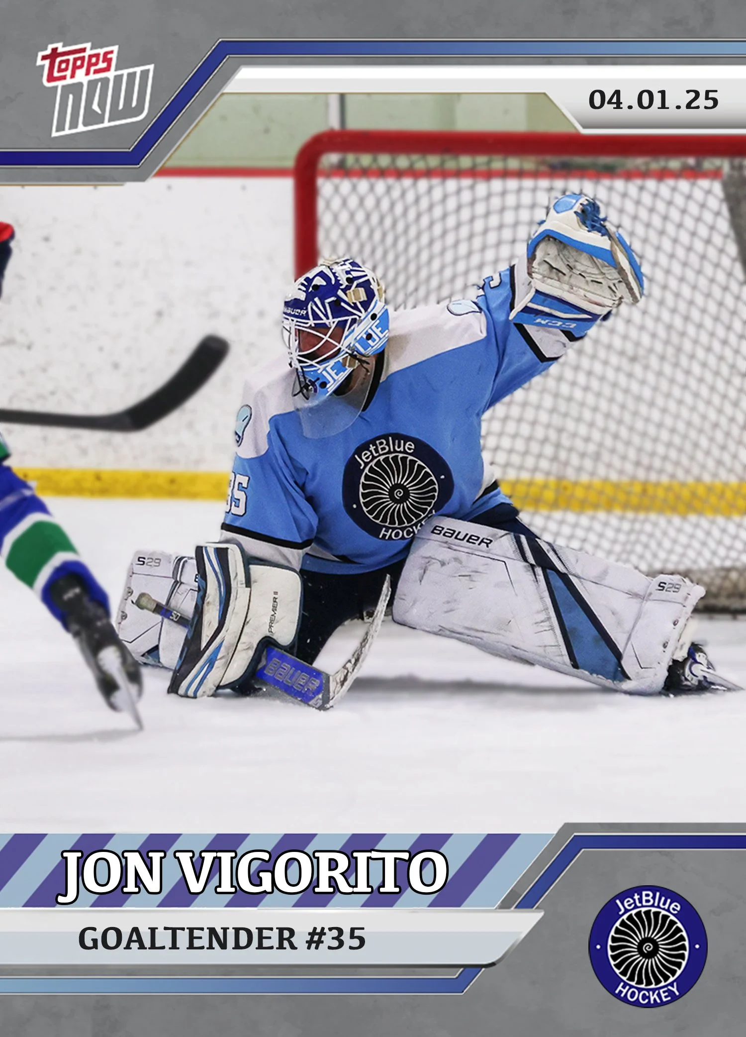 Hockey goalie in blue uniform making a save on the ice rink during a game.