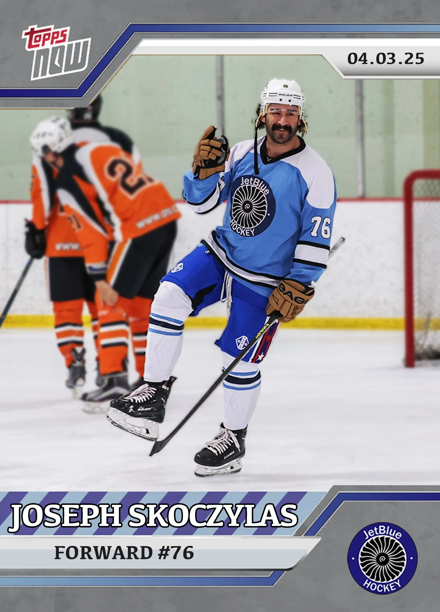 Hockey player Joseph Skoczylas wearing a blue and white jersey with the number 76, holding a hockey stick, on an ice rink.