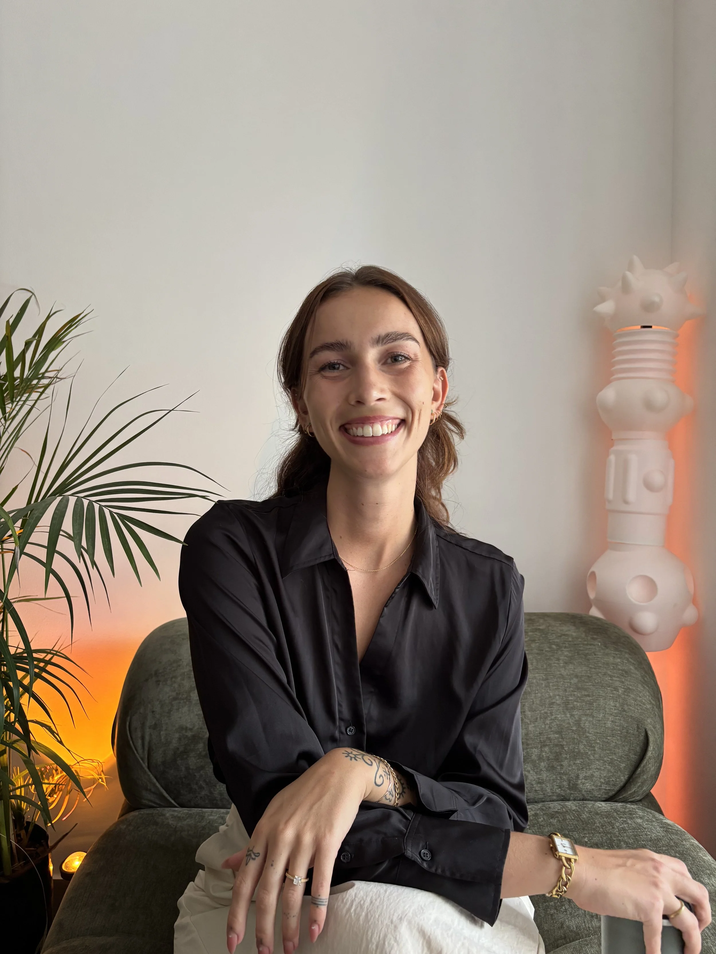 Portrait of Sara Aarosin, sexologist and relationship therapist, seated in a black shirt.