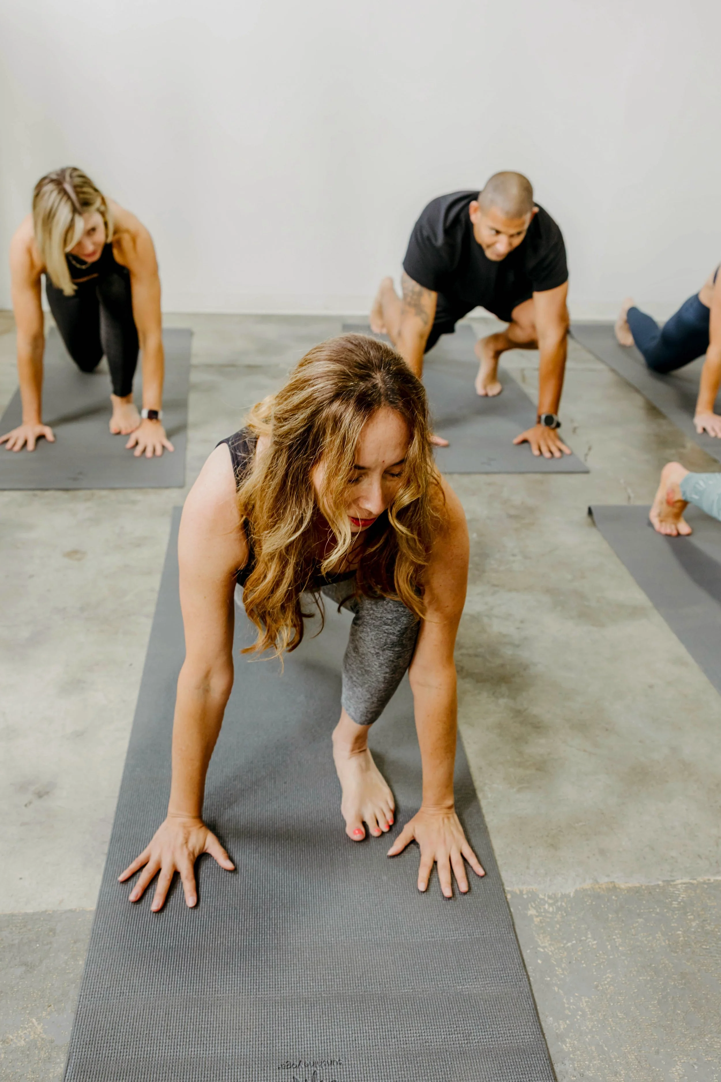 Group of yogis in runners lunge.