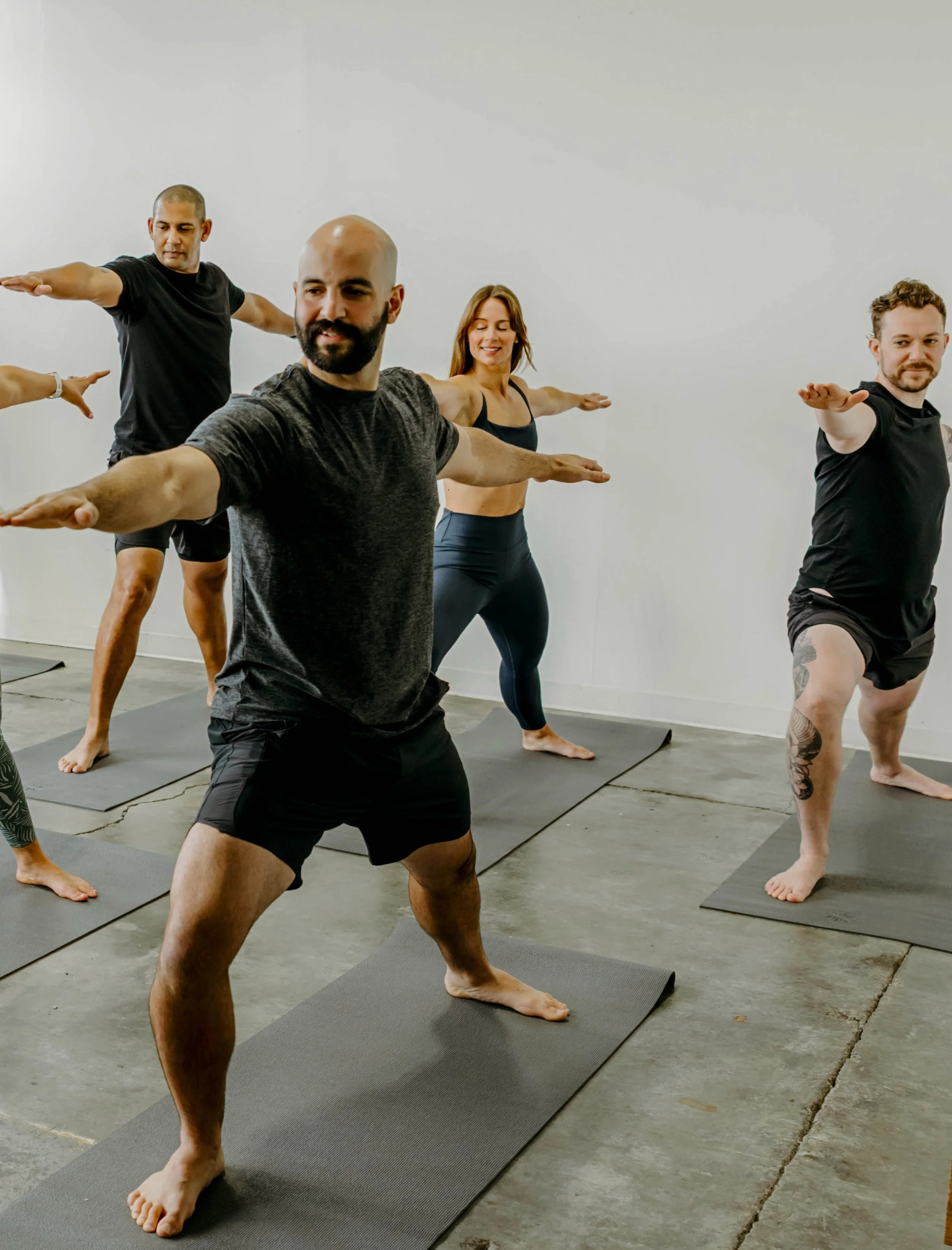 Group of yogis in Warrior 2.