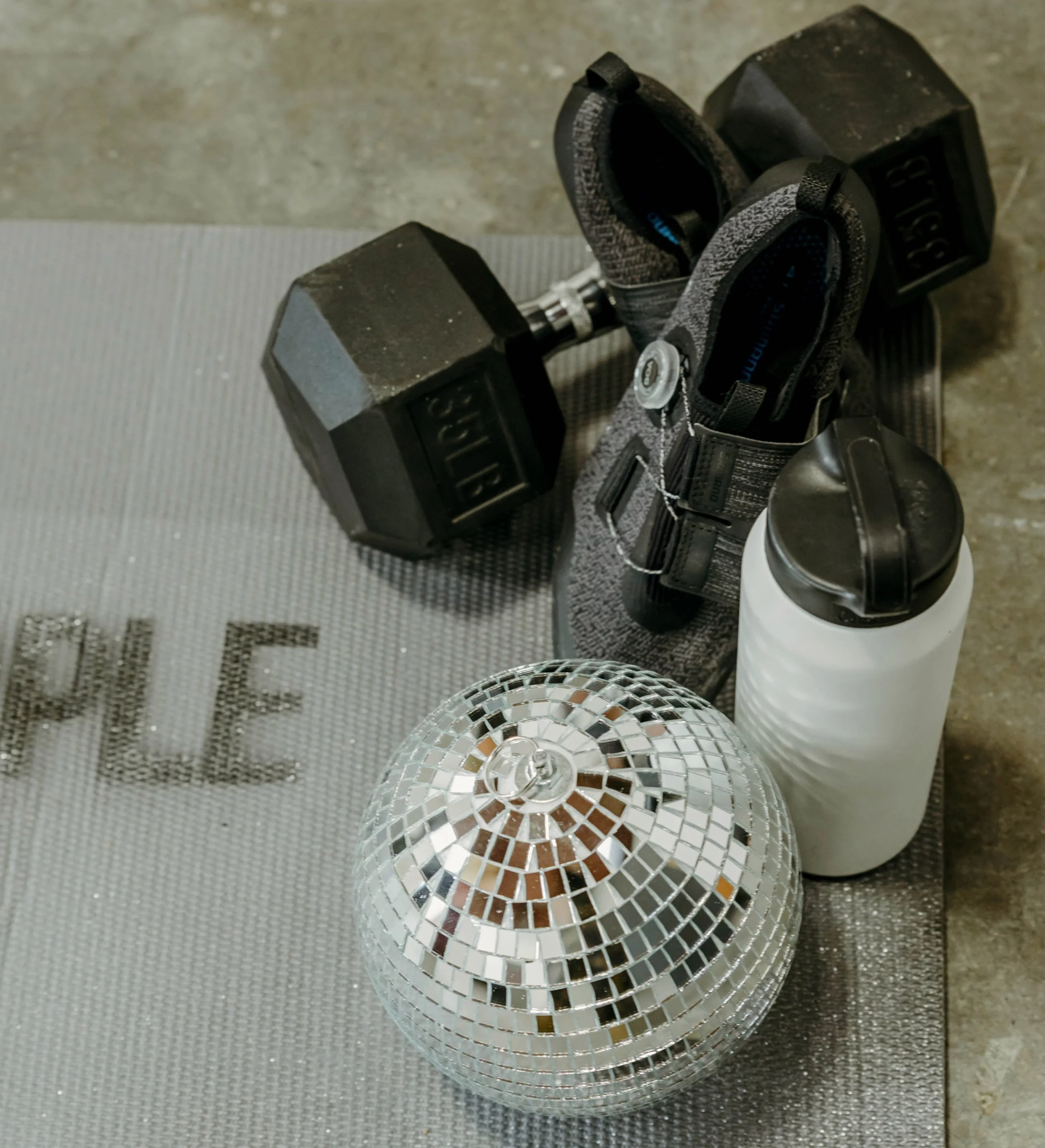 Disco Ball with water bottle, cycling shoes, and weight