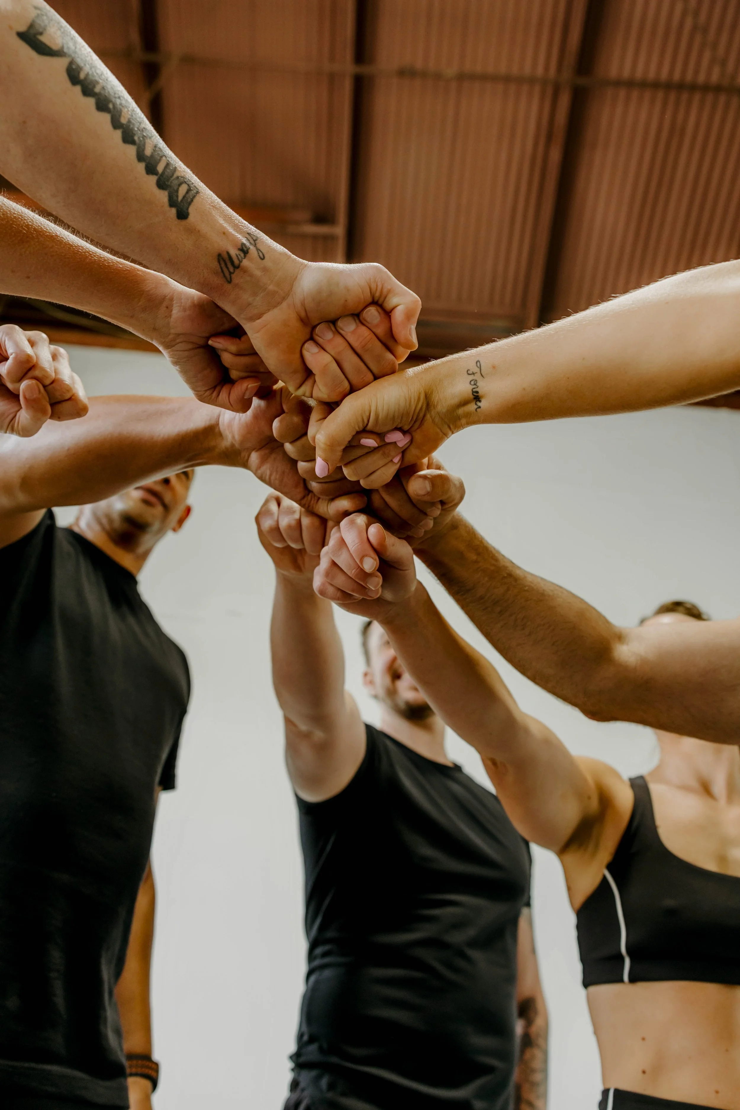 Group of people with their hands in a circle