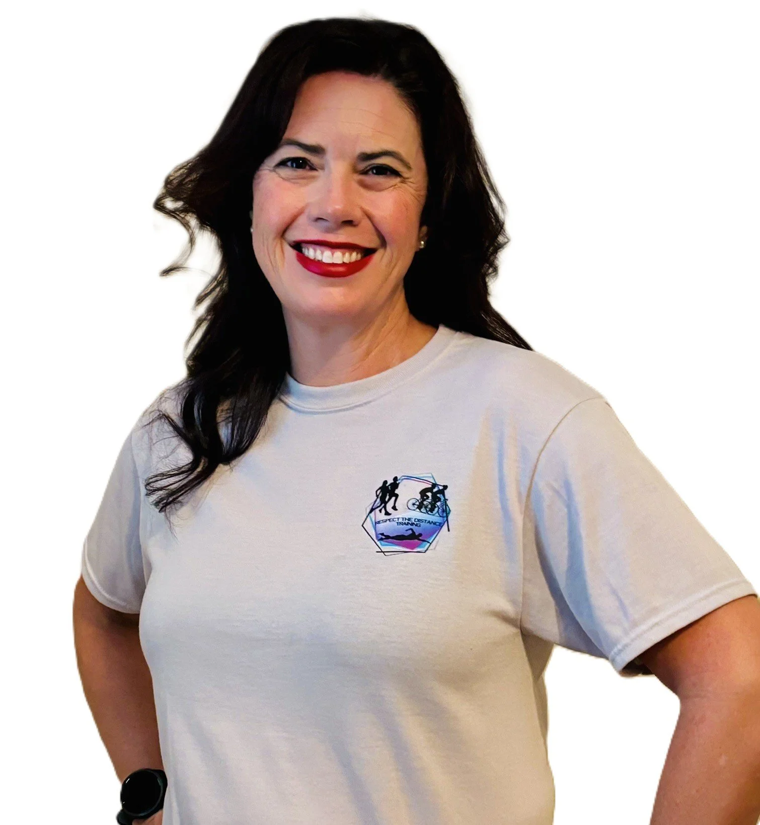 A woman with dark, wavy hair smiling wearing a cream t-shirt with a logo of a person running, a person cycling, and a person swimming, with the words 'Respect the Distance' underneath.