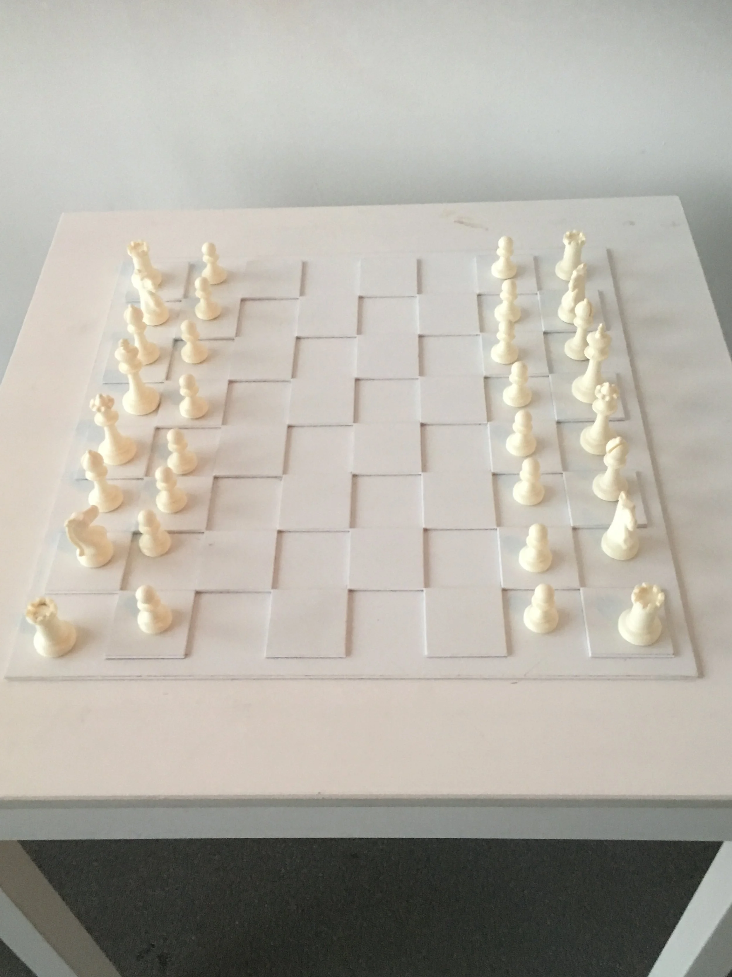 Yoko Ono's art, white chess pieces arranged in their starting positions.
