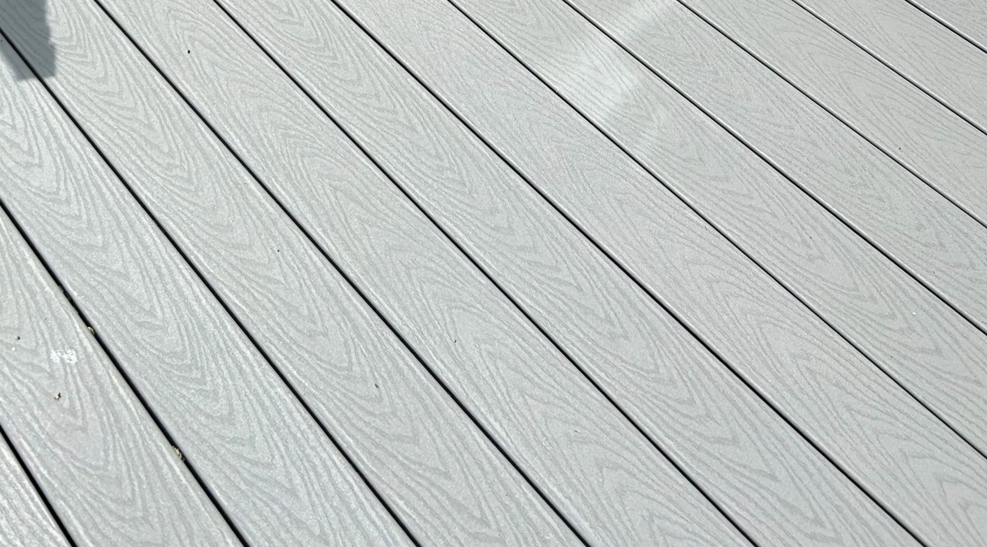 Close-up view of gray wooden planks with a textured wood grain pattern.