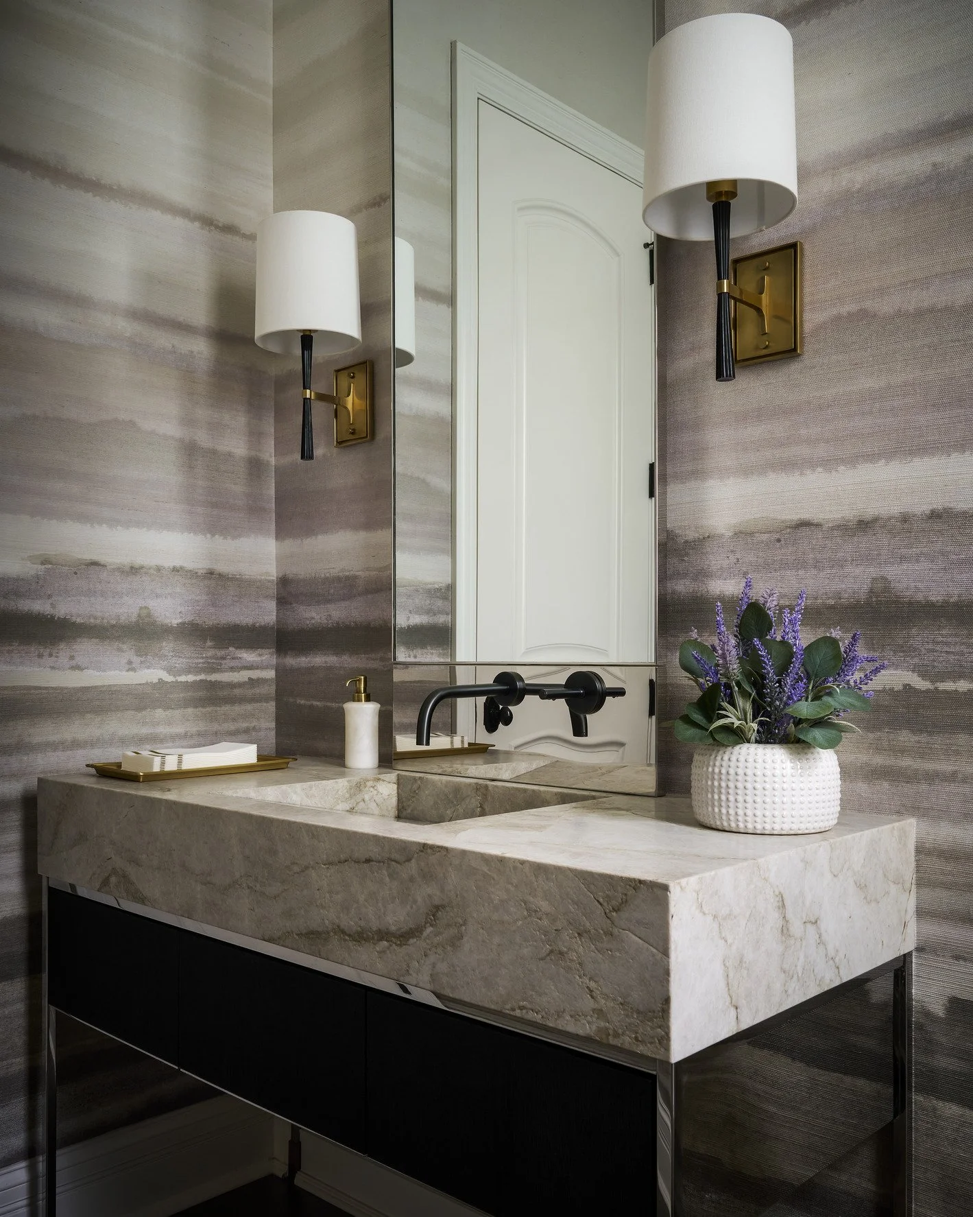 Custom home bar with patterned wallpaper, marble countertop, and built-in cabinetry in Kenilworth interior design project.