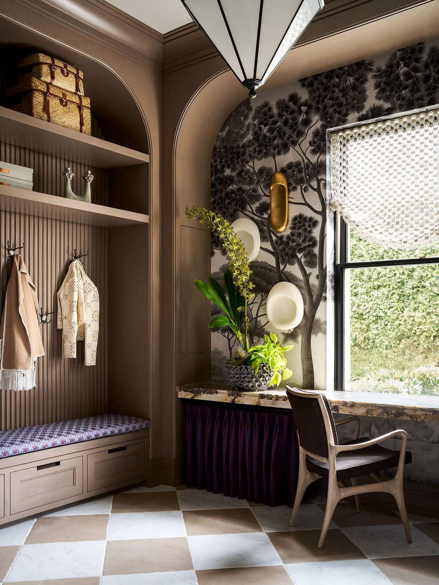 Custom mudroom with built-in bench seating, ribbed wood paneling, open shelving, coat hooks, and marble checkerboard flooring.
