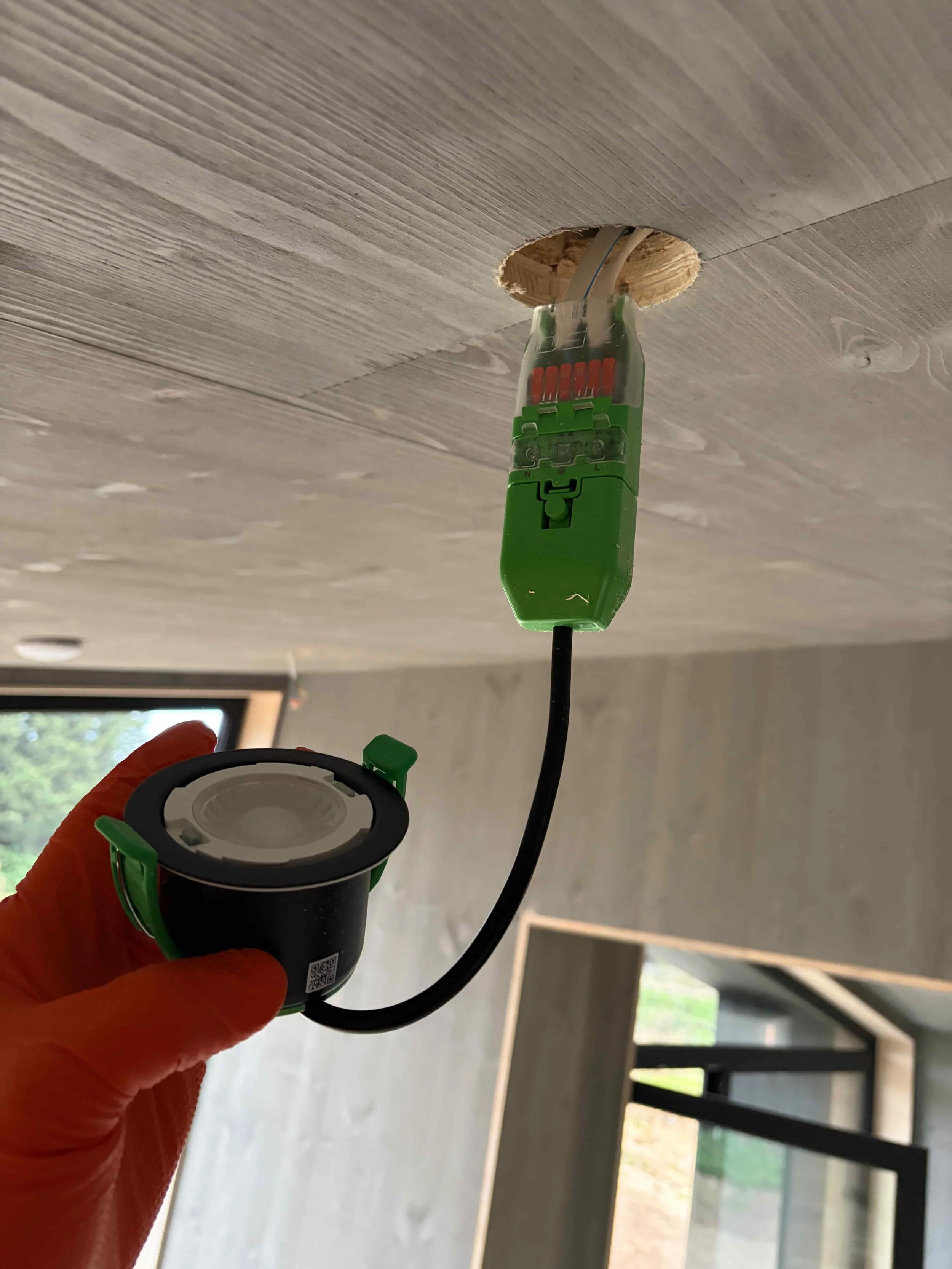 LED downlights being installed by an electrician in Bristol
