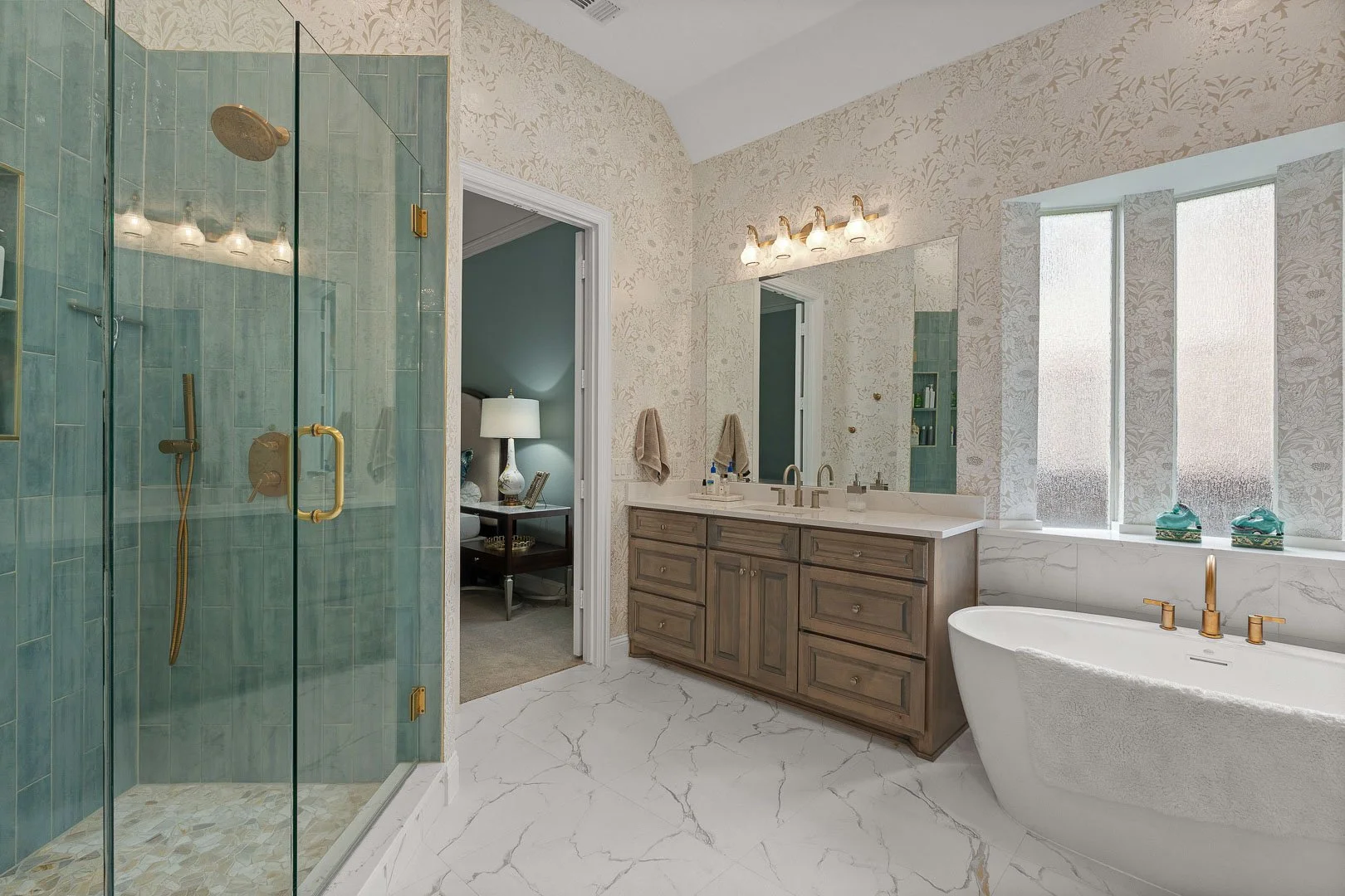 Modern bathroom with walk-in shower, double vanity, bathtub, and large window with frosted glass.