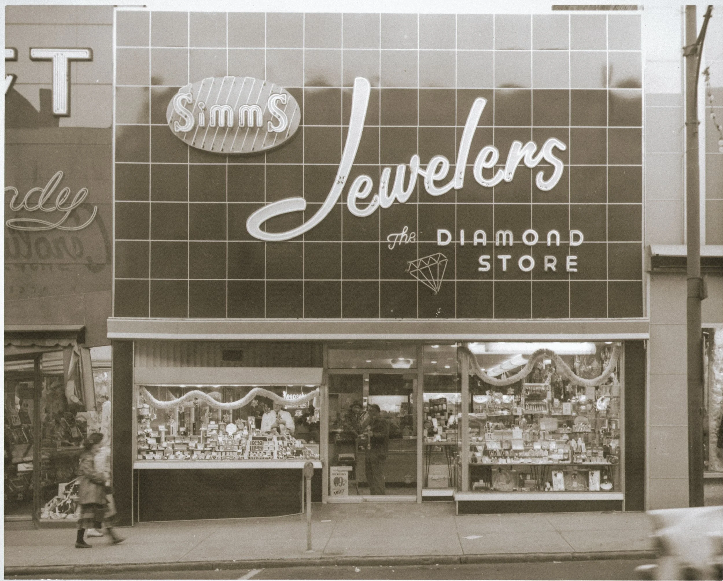 the original storefront image of simms with a large signage