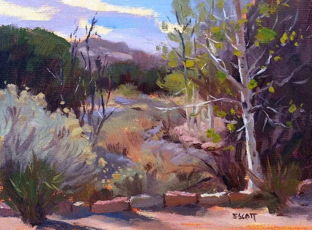 A landscape painting of a dry, desert-like scene with trees, bushes, rocks, and a clear blue sky.