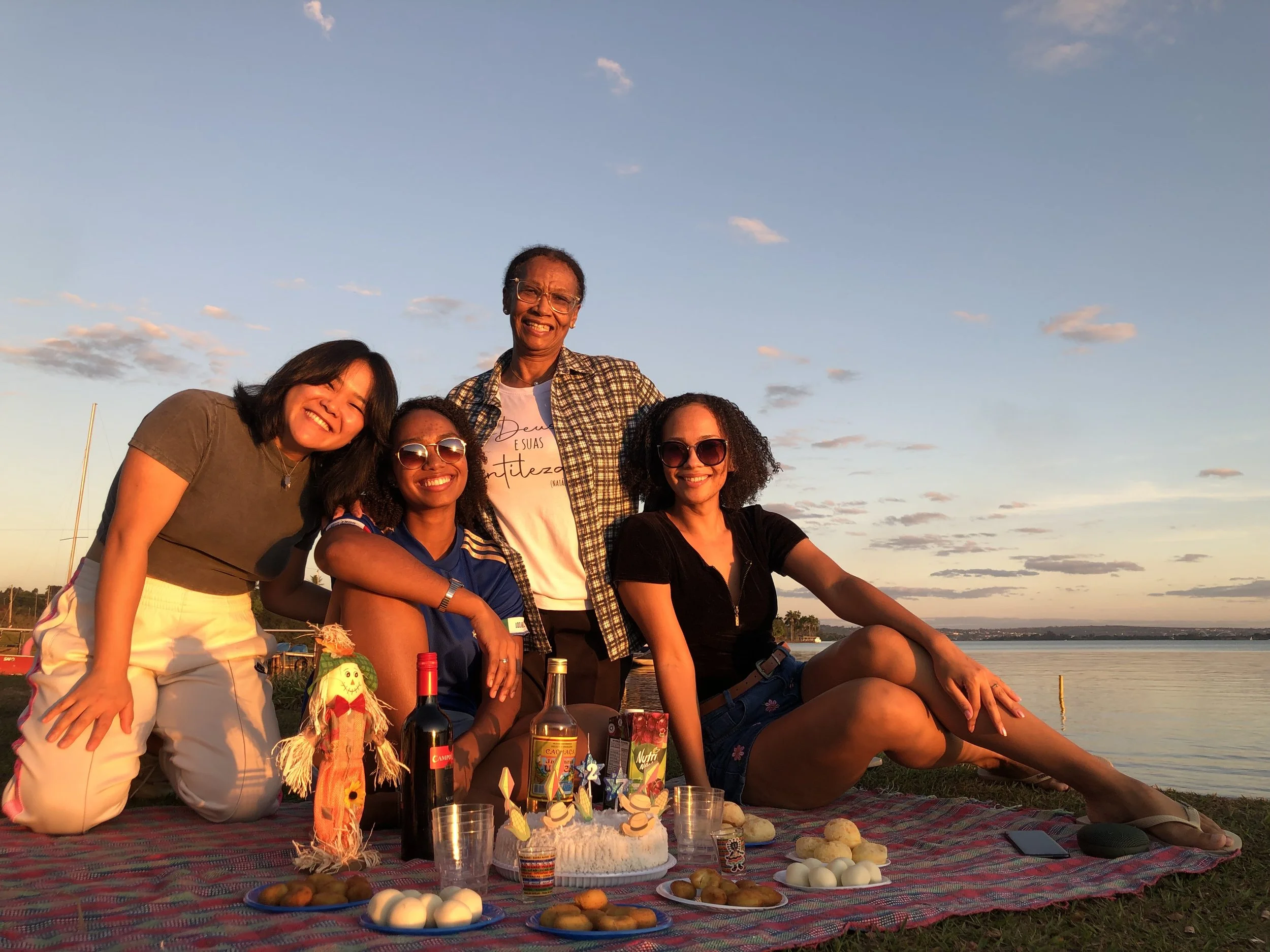 Four women having a picnic during sunset