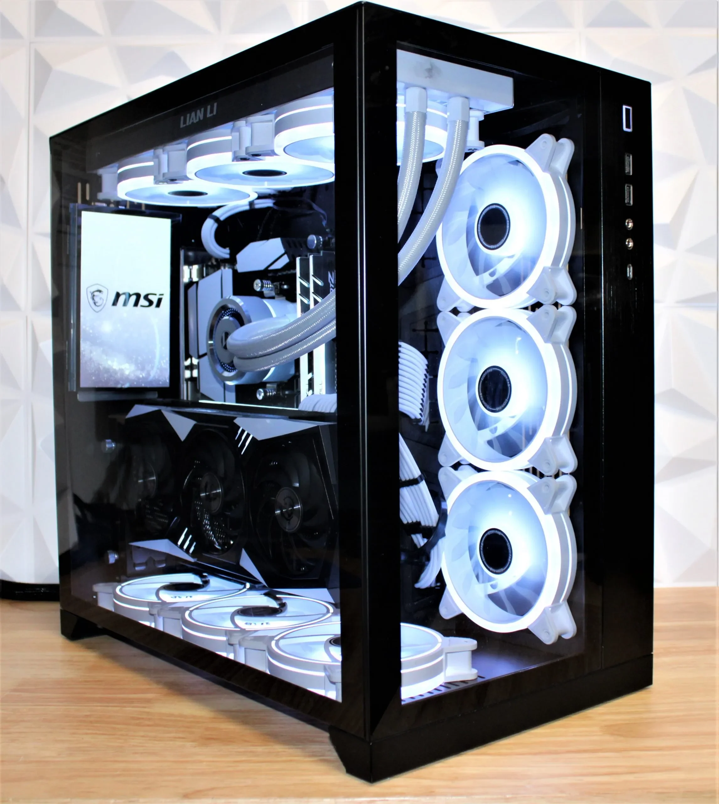 A custom-built gaming PC with a black case featuring a transparent side panel, white LED-lit cooling fans, and high-end components visible inside.
