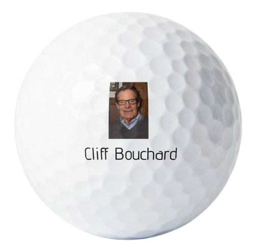 Close-up of a golf ball with a small photo and the name 'Cliff Bouchard' printed on it.