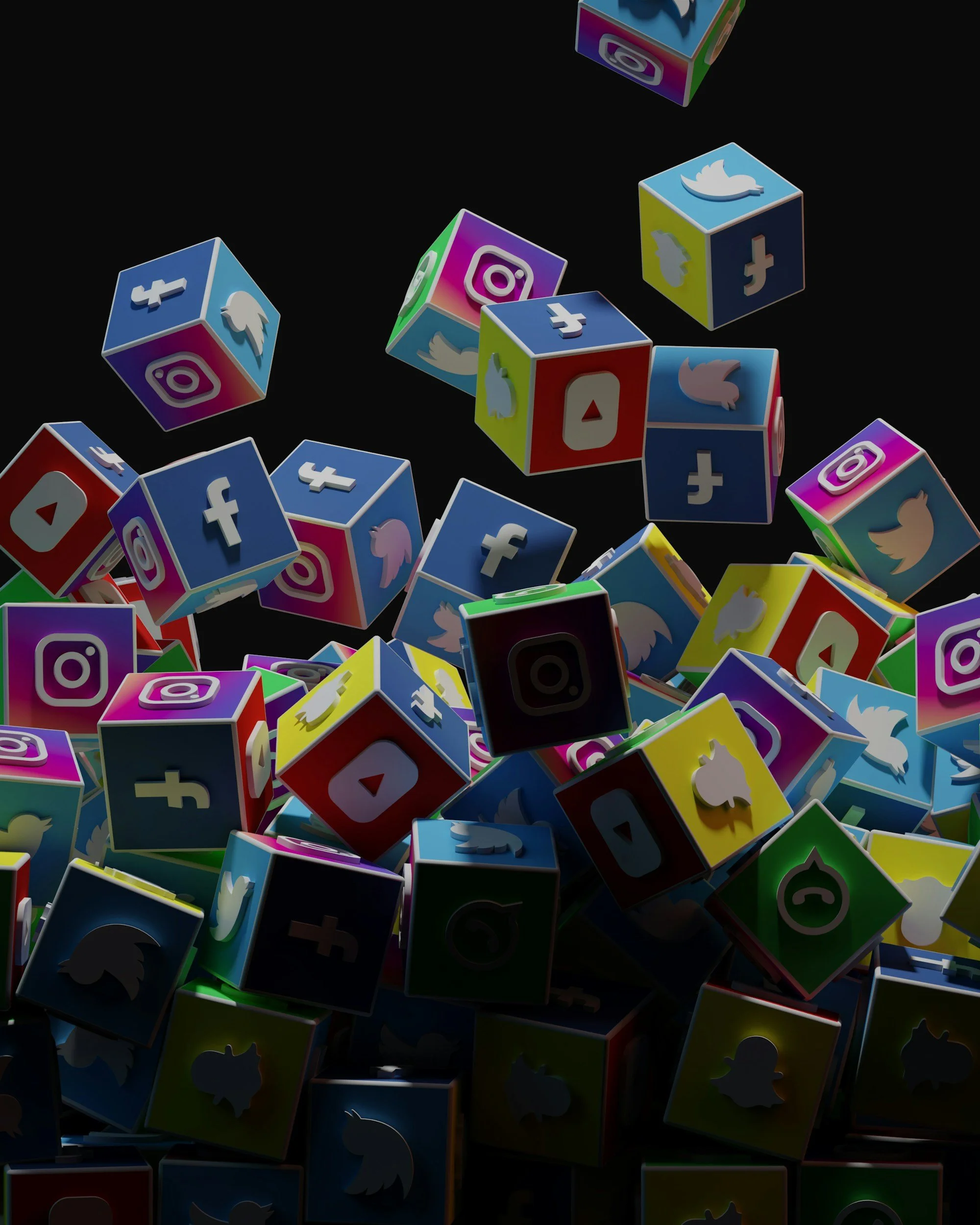Colorful social media icons on small cubes falling against a black background.