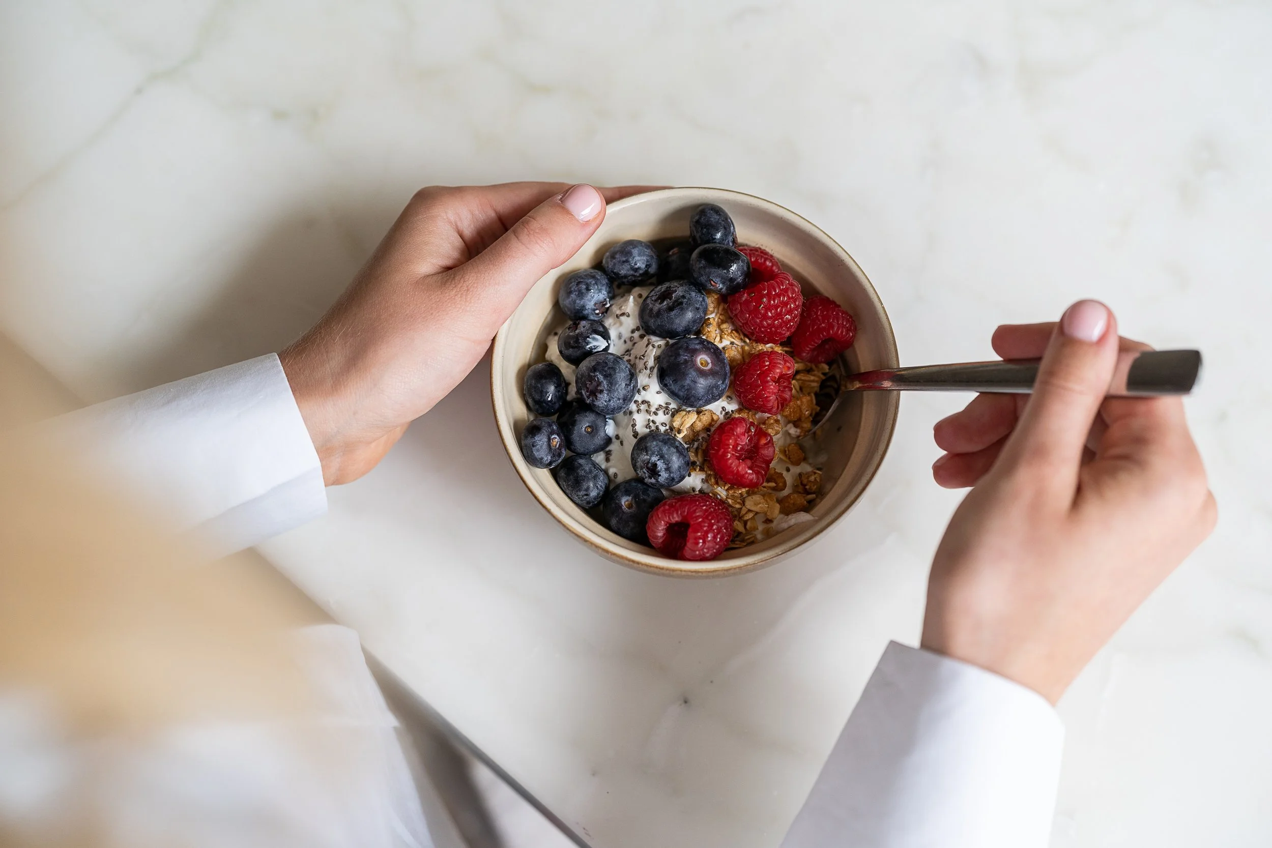 A bowl of natural Greek yoghurt topped with berries and chia seeds to support gut health