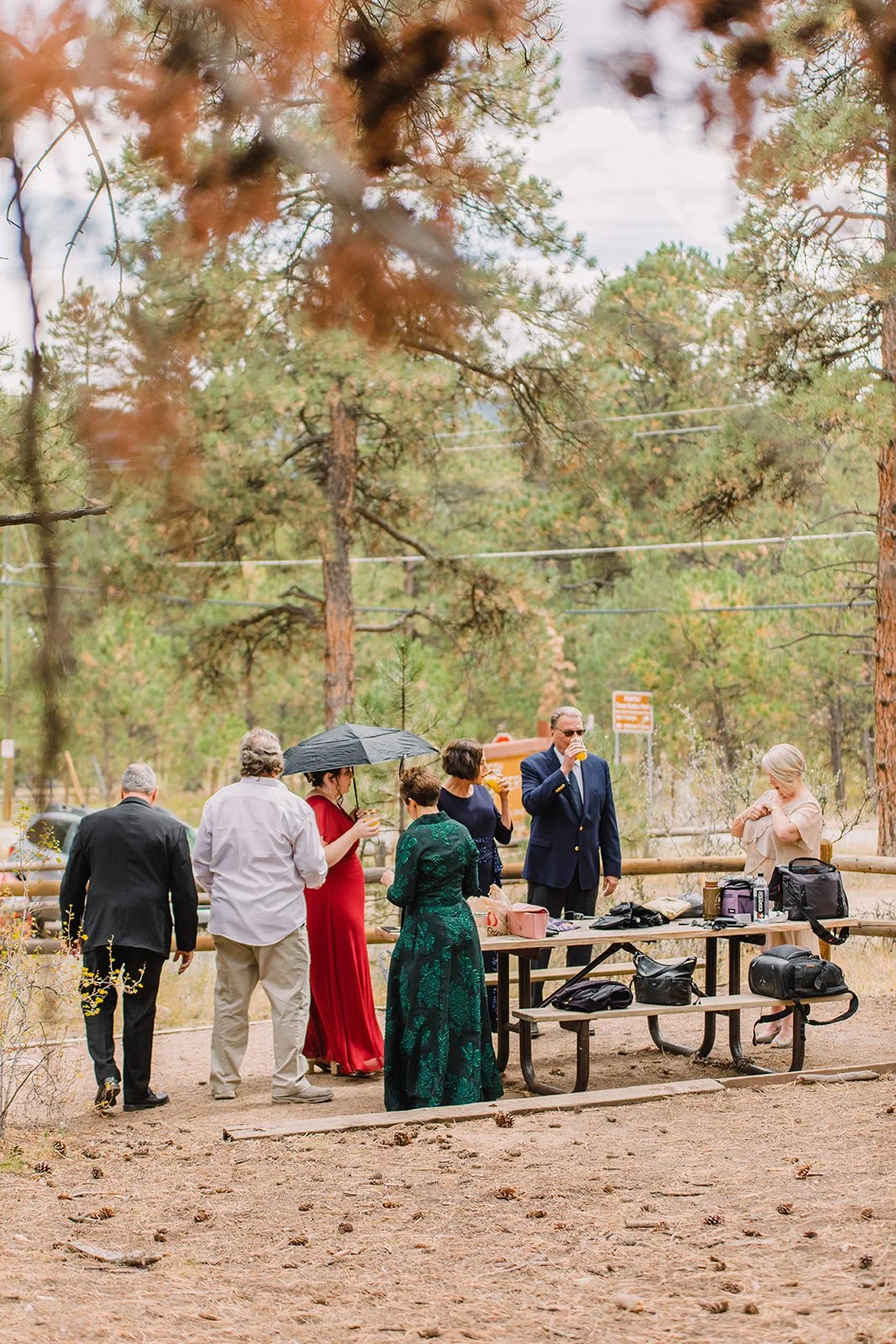 Elegant Colorado Springs wedding reception with fall leaves red and ivory florals and mountain views
