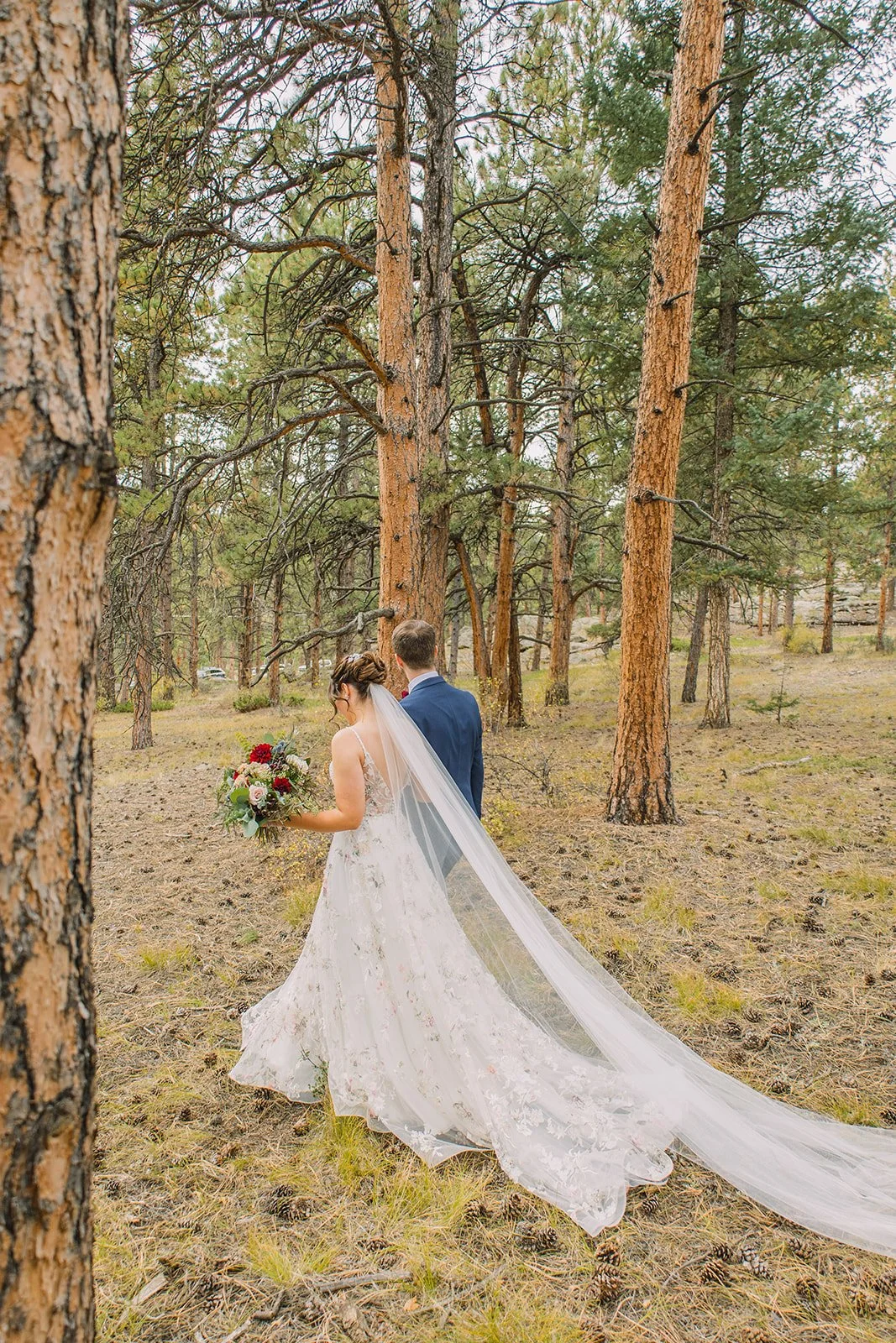 Elegant Colorado Springs wedding reception with ivory and red florals and mountain views