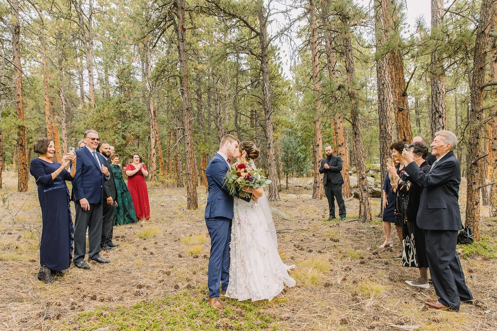 Elegant Colorado Springs wedding reception with ivory and red florals and mountain views