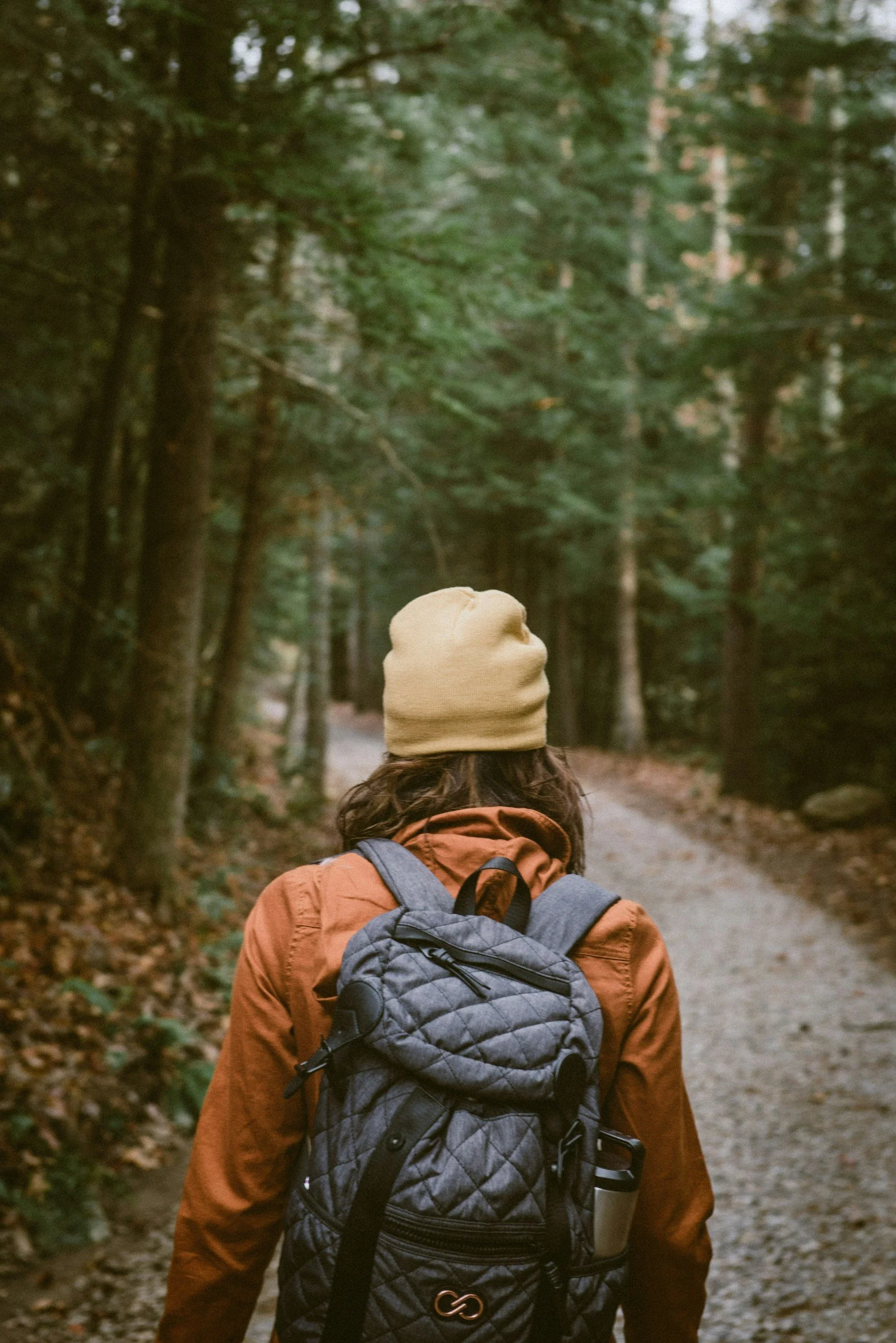 Woman hiking through the woods.