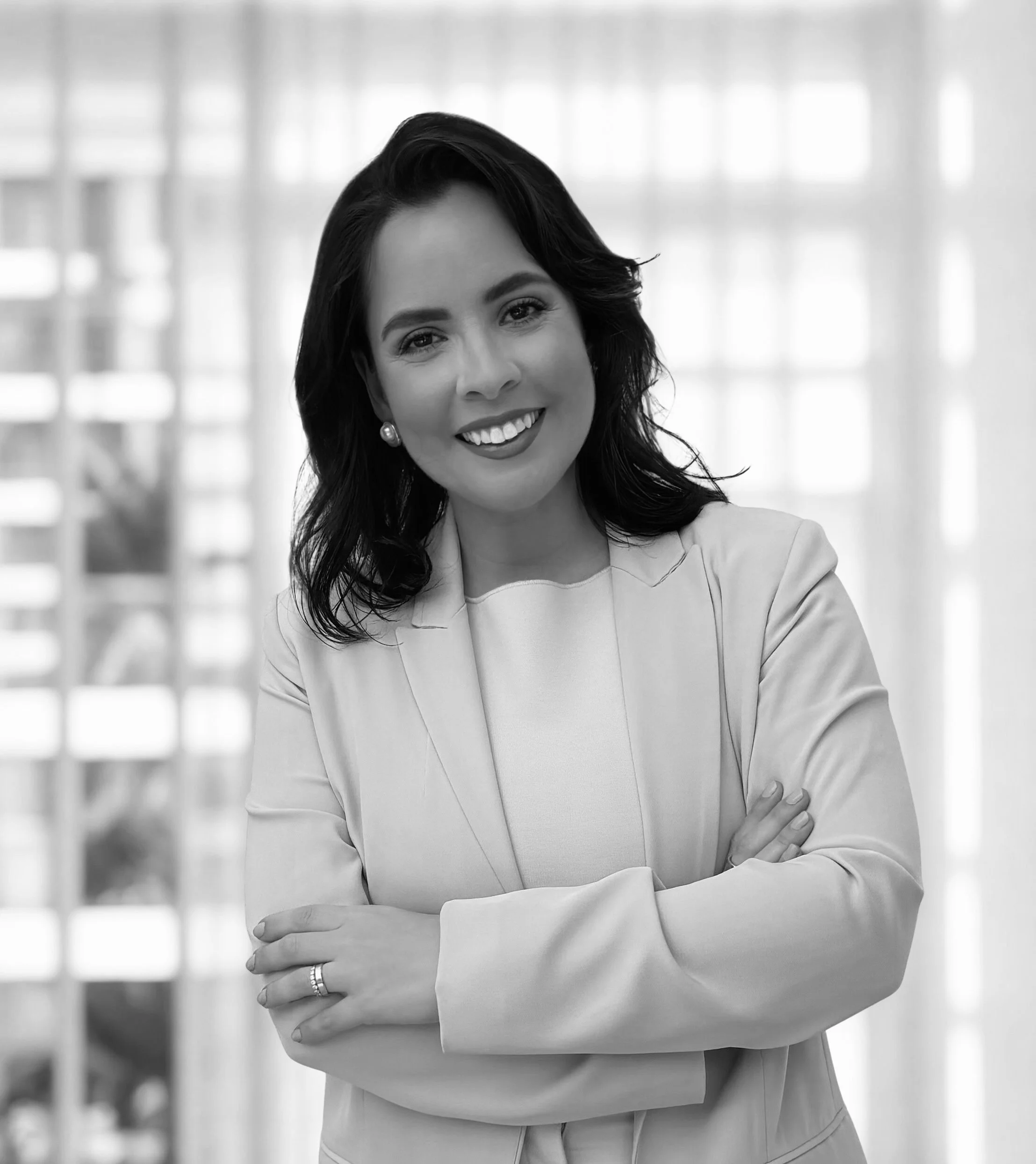 Portrait of Claudia Caporossi, Miami real estate agent, smiling in a professional setting