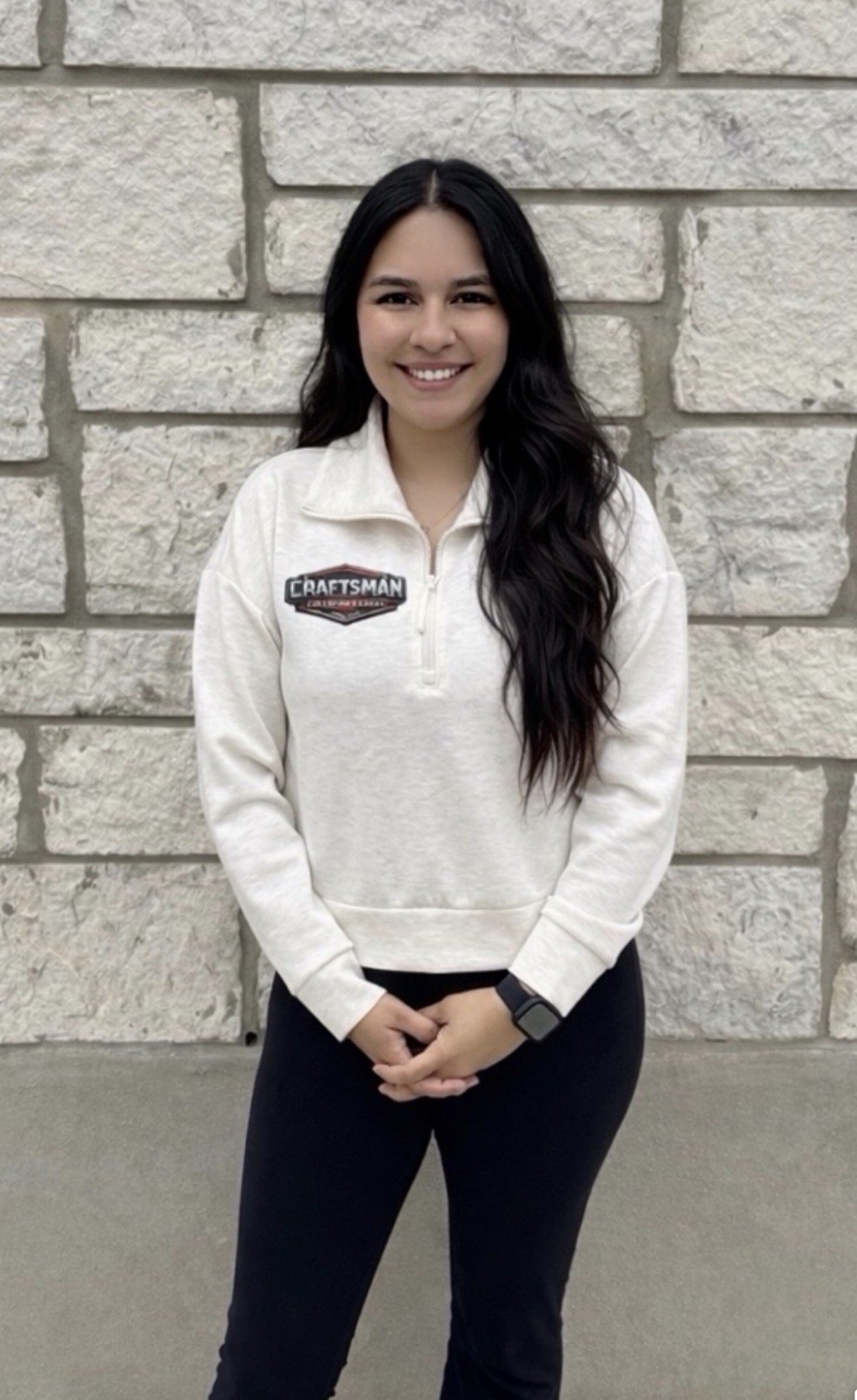 A metal adjustable wrench lies on a beige surface.